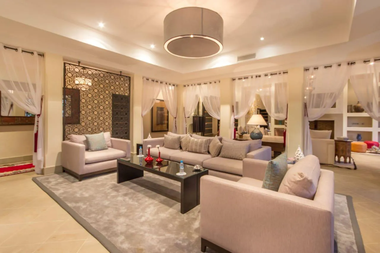 Villa Kyma, private villa rental at the Four Seasons Resort, Marrakech: living room with sofas and moucharabieh screen