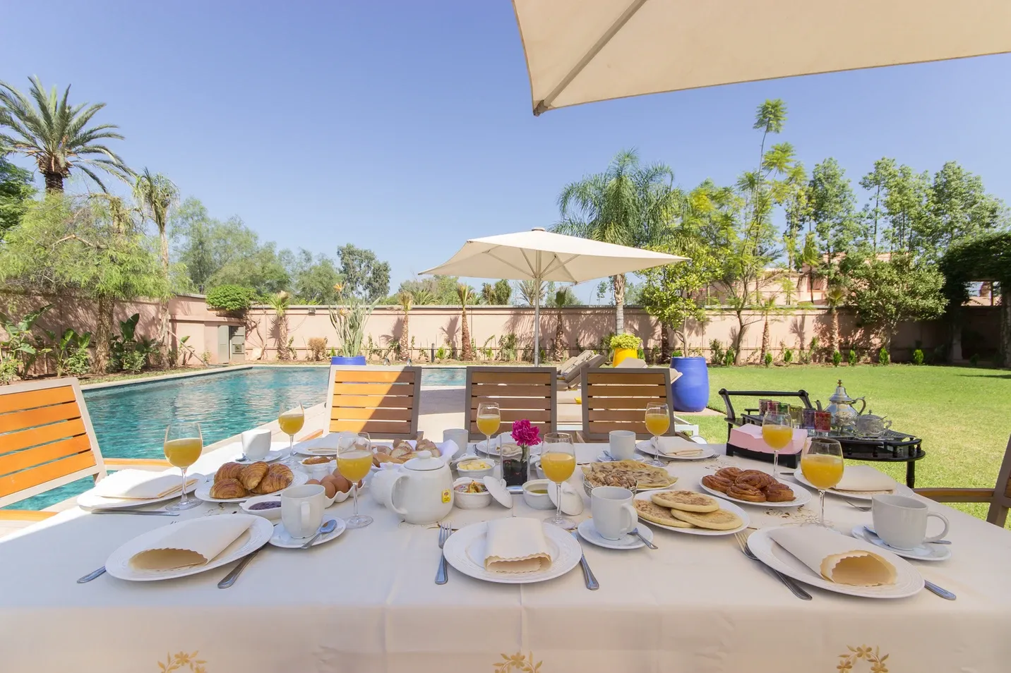 Villa Kyma, private villa rental at the Four Seasons Resort, Marrakech: breakfast table set by the pool