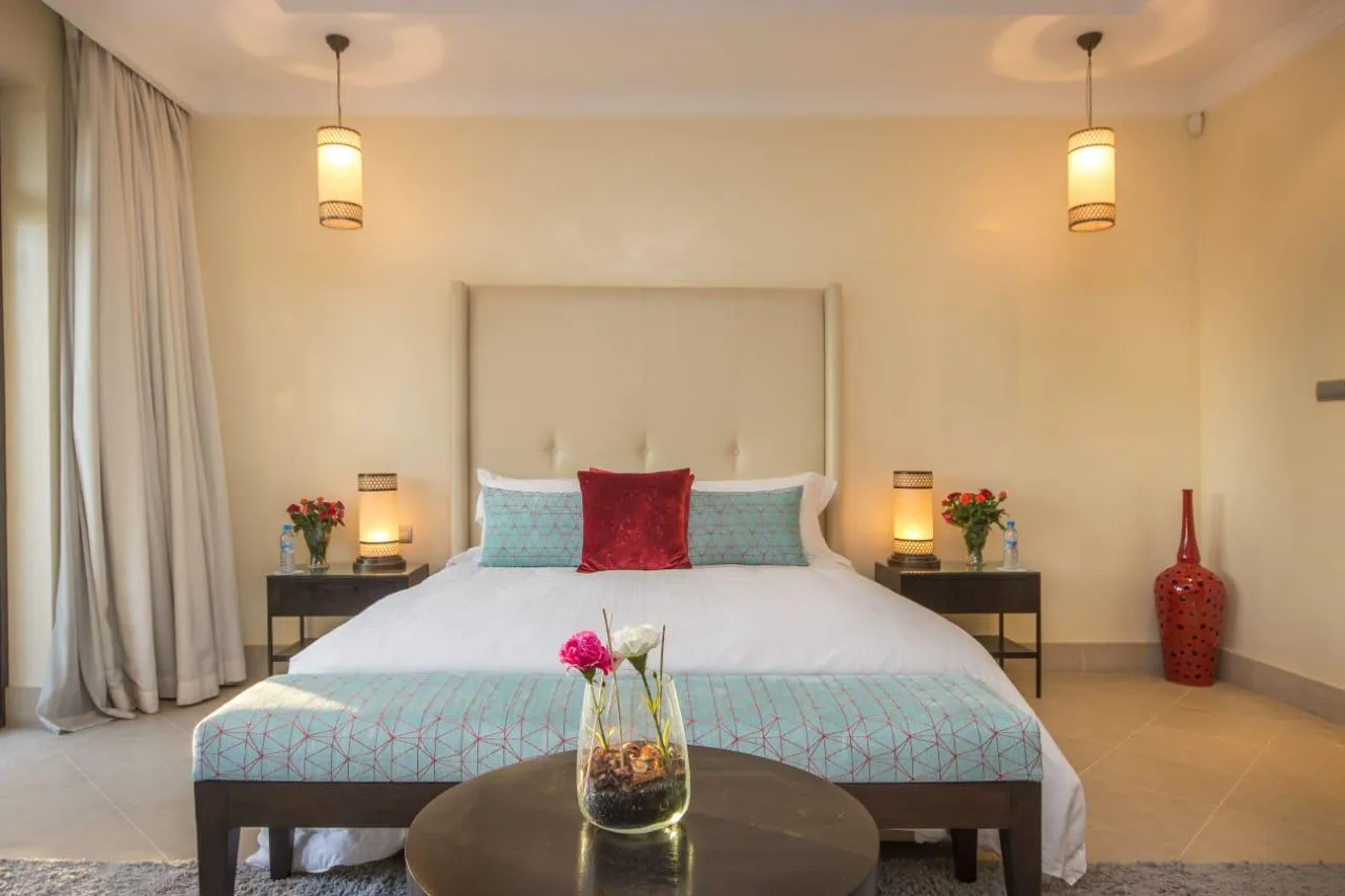 Villa Kyma, private villa rental at the Four Seasons Resort, Marrakech: bedroom with turquoise bedspread