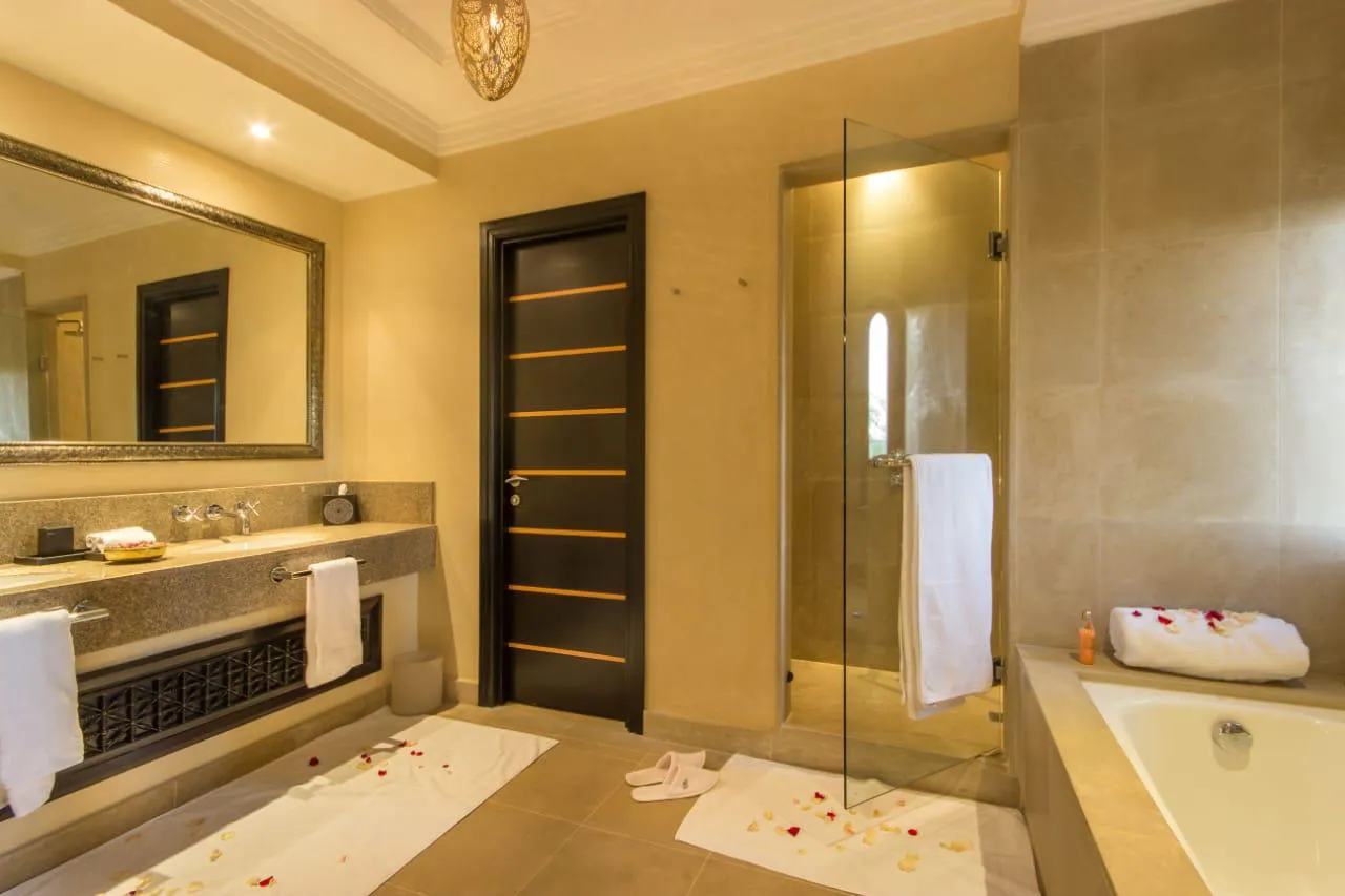 Villa Kyma, private villa rental at the Four Seasons Resort, Marrakech: bathroom with glass shower and bathtub