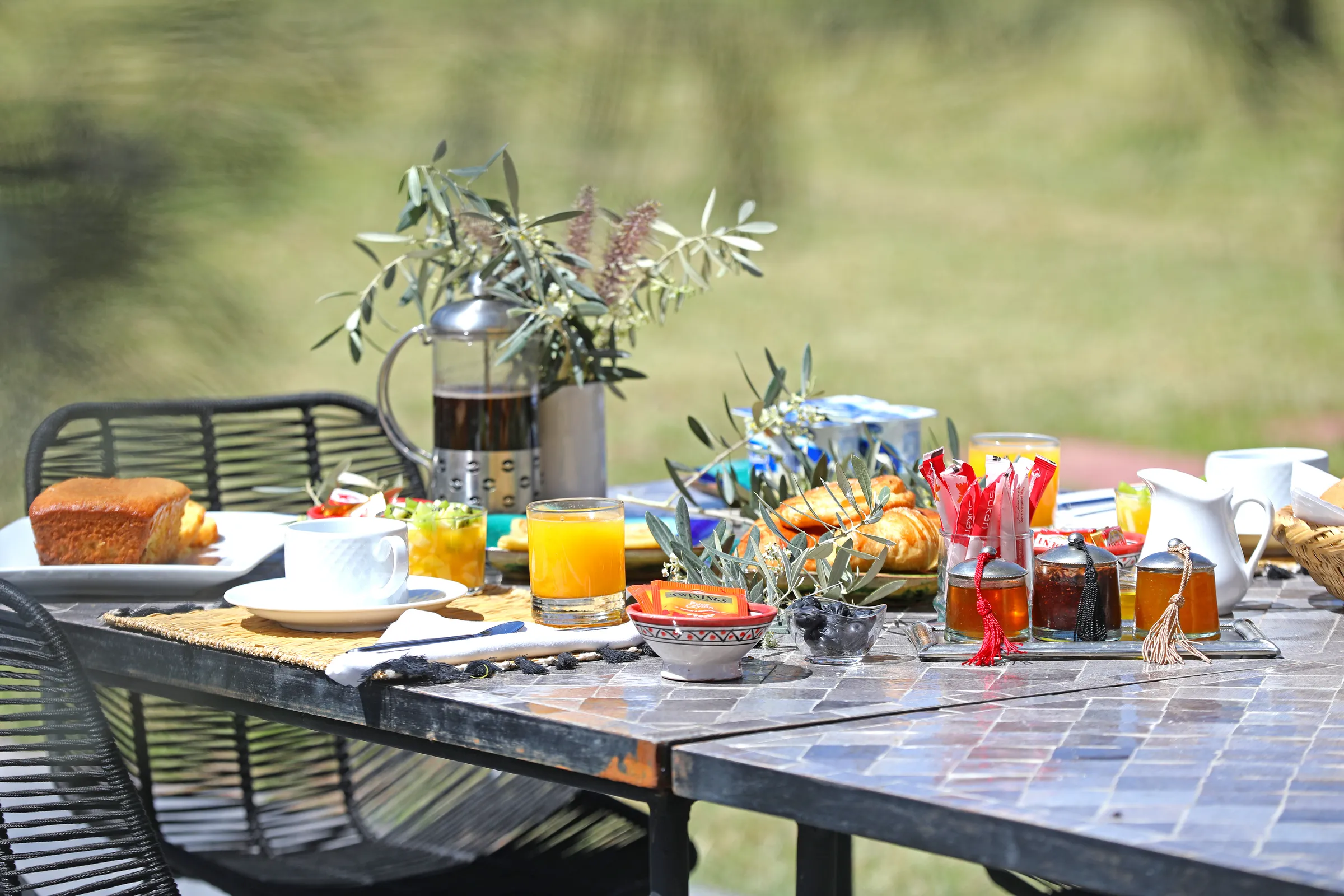 Villa Iliana, private villa rental on the Route de l'Ourika, Marrakech: breakfast table set in the garden