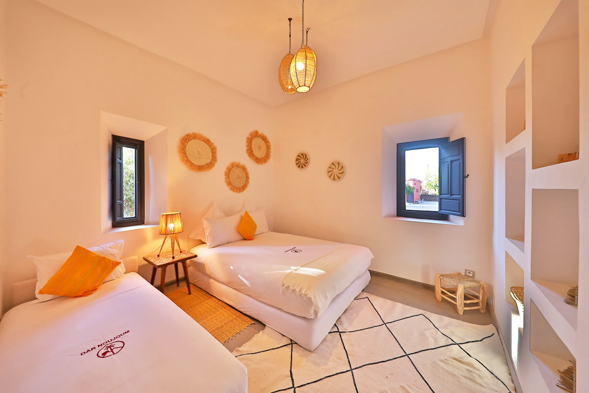 Villa Iliana, private villa rental on the Route de l'Ourika, Marrakech: twin bedroom with woven wall decorations