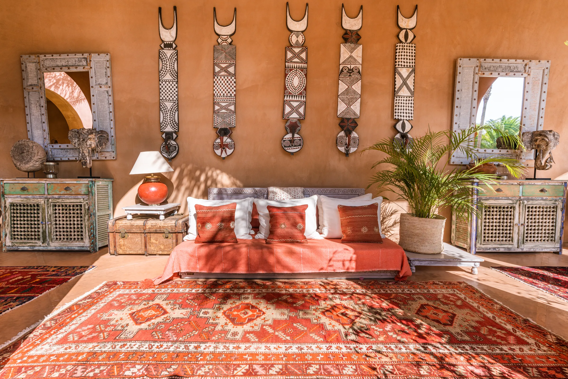Villa Lyra, private villa rental in Ouled Hassoune, Marrakech: covered gallery lounge with daybed and ethnic art