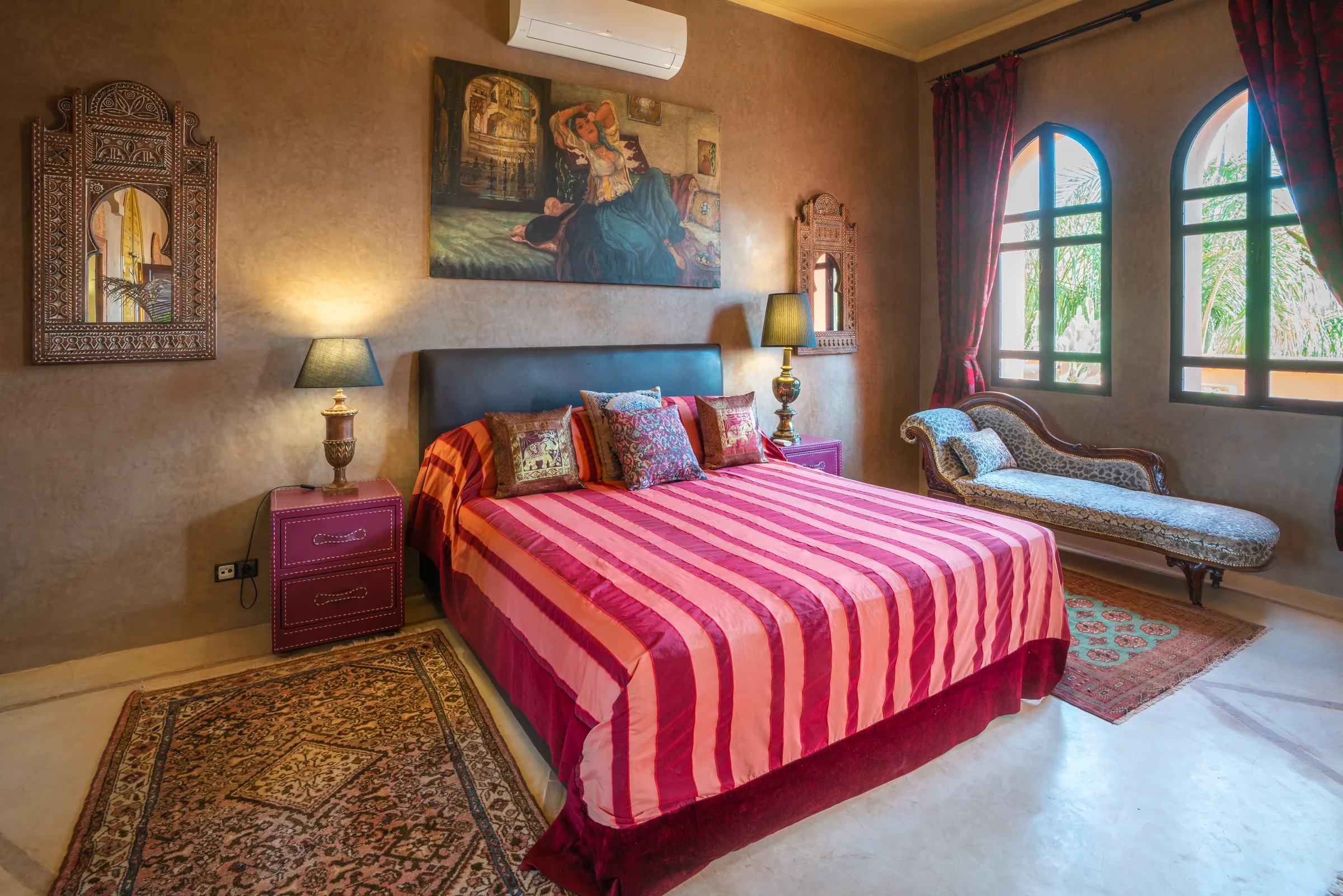 Villa Lyra, private villa rental in Ouled Hassoune, Marrakech: bedroom with striped bedspread and chaise longue
