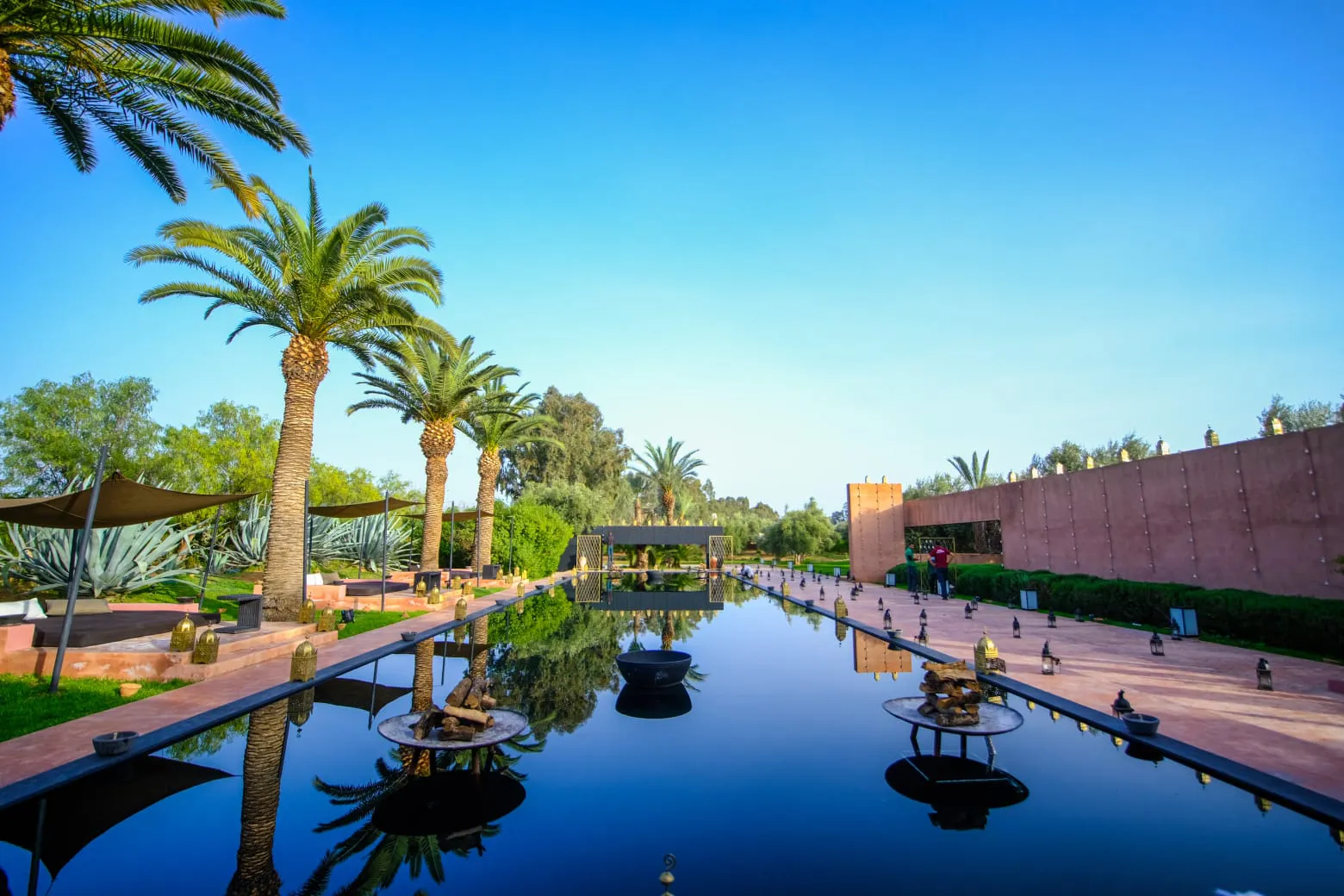 Villa Phaedra, private estate rental in Ouled Hassoune, Marrakech: long pool and palm trees by day