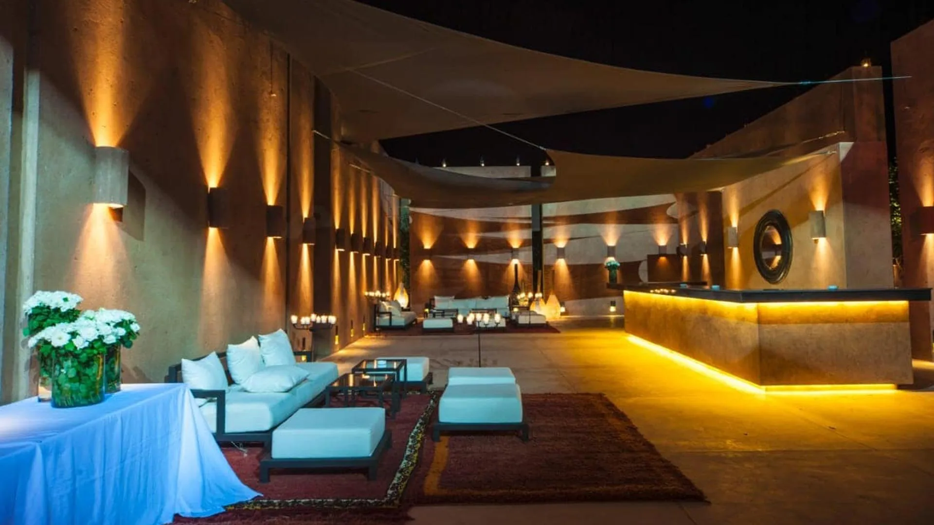 Villa Phaedra, private estate rental in Ouled Hassoune, Marrakech: illuminated lounge with turquoise seating