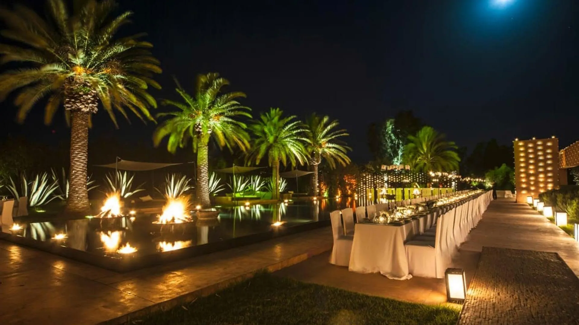 Villa Phaedra, private estate rental in Ouled Hassoune, Marrakech: dinner in the palm garden at night