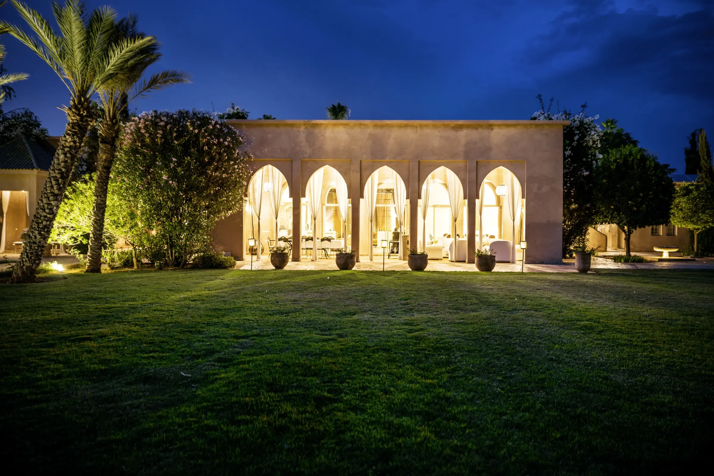 Villa Danae, private villa rental in Sidi Abdellah Ghiat, Marrakech: arcaded façade lit up at night