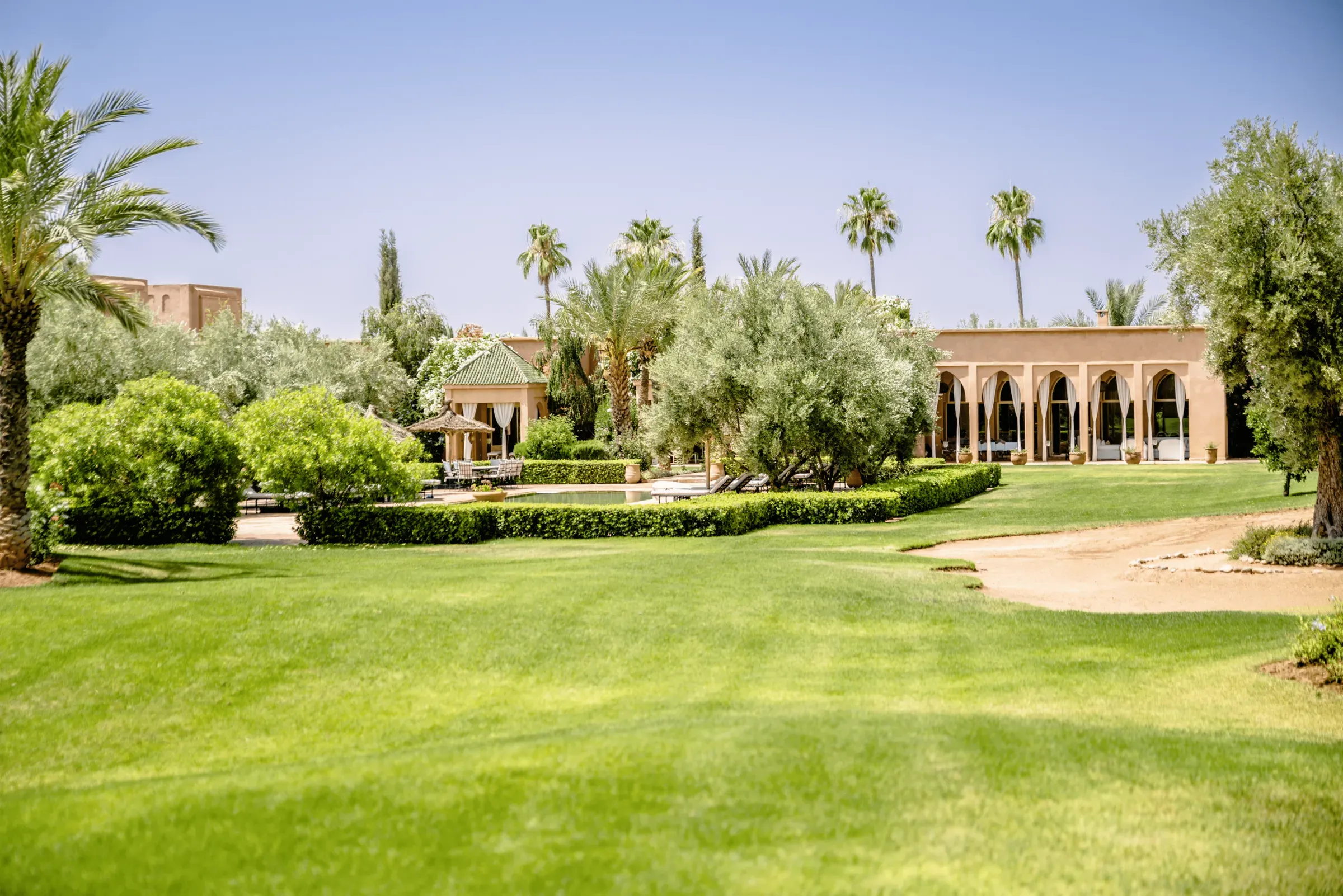 Villa Danae, private villa rental in Sidi Abdellah Ghiat, Marrakech: lawn and arcaded façade
