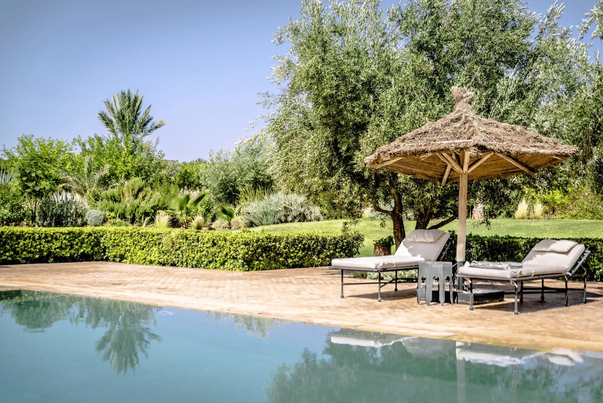 Villa Danae, private villa rental in Sidi Abdellah Ghiat, Marrakech: poolside loungers under a parasol
