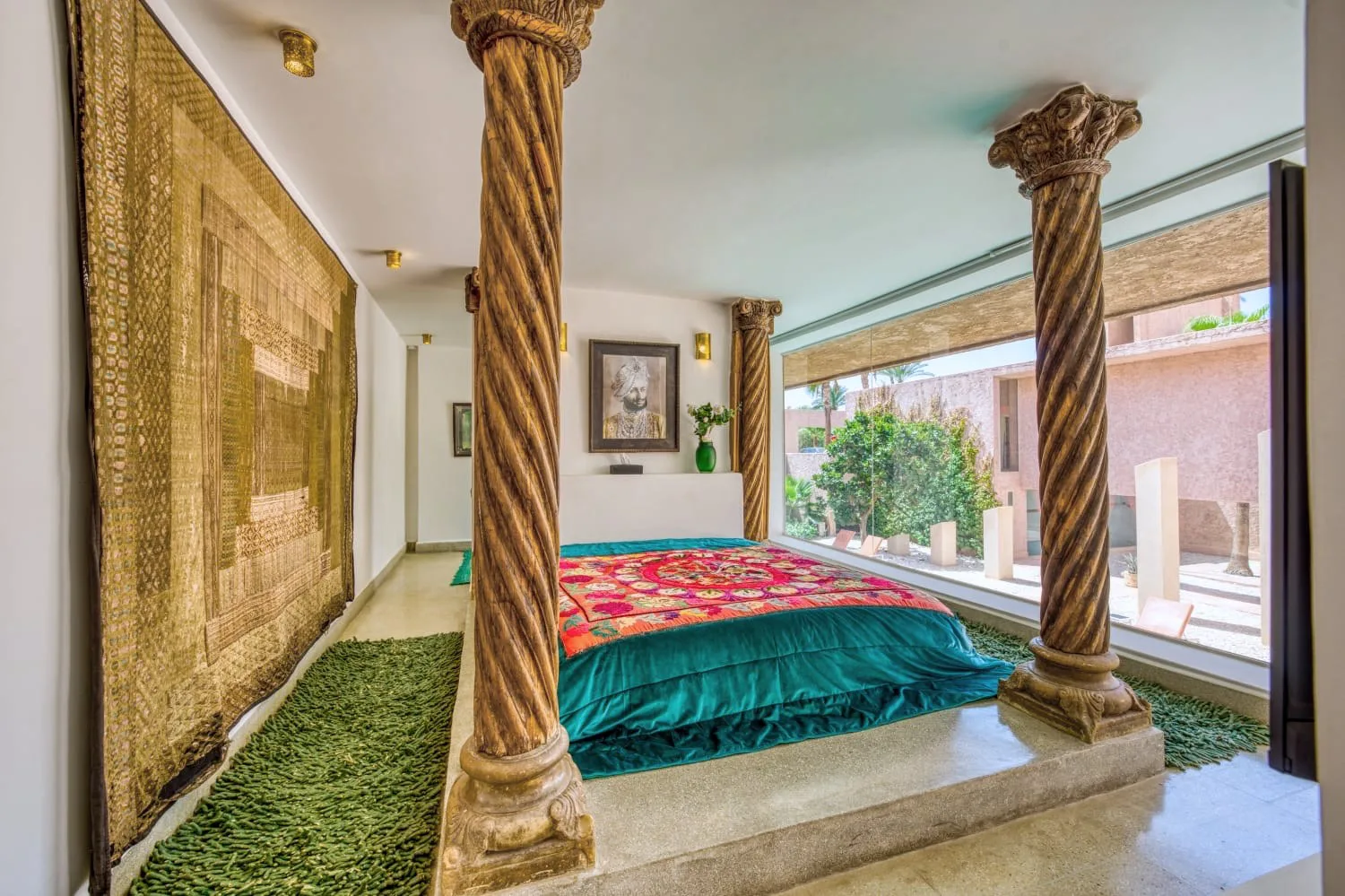 Villa Ianthe, private villa rental in the Palmeraie, Marrakech: suite with carved wooden columns and garden view