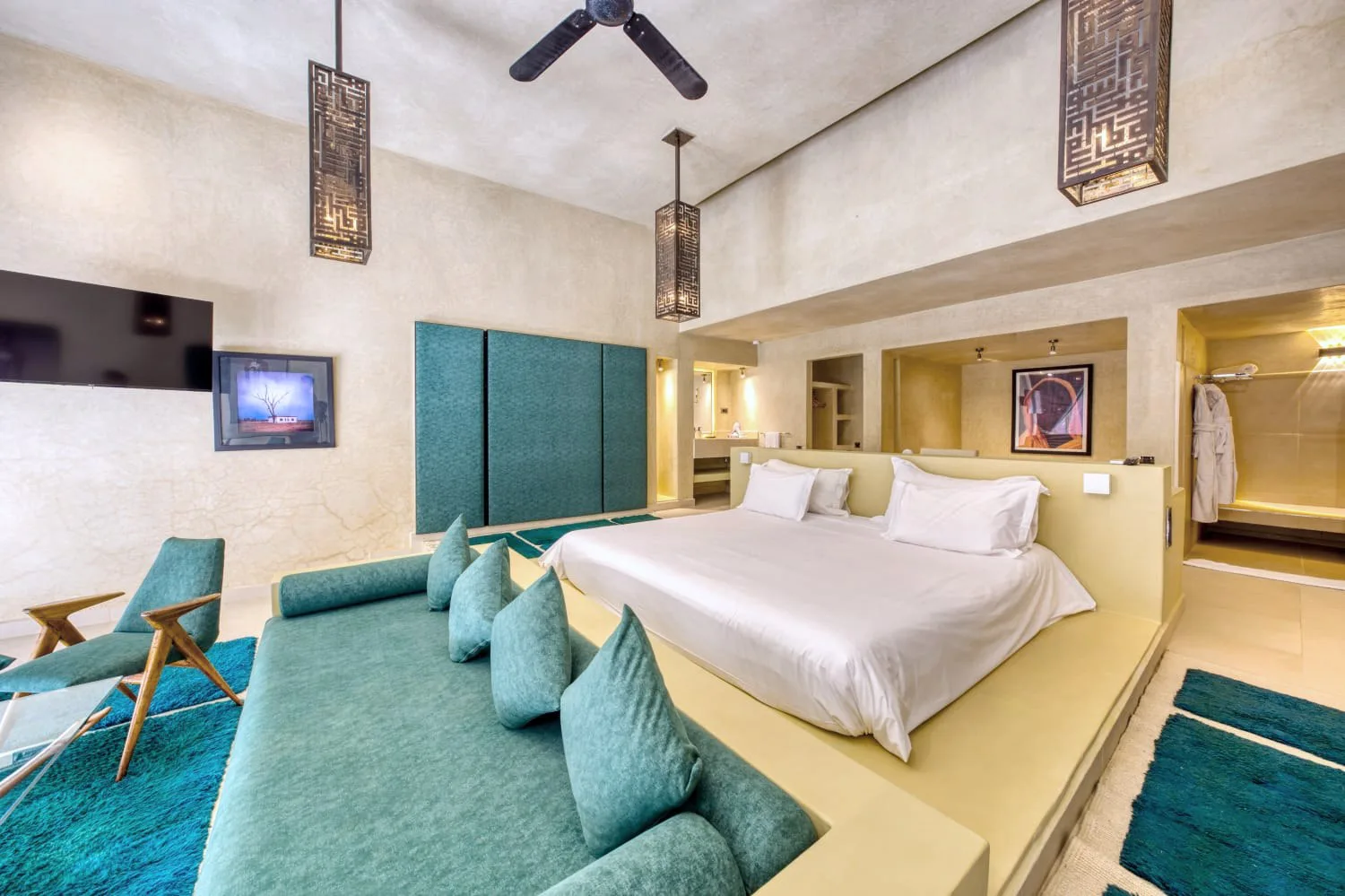 Villa Ianthe, private villa rental in the Palmeraie, Marrakech: suite with turquoise lounge and king-size bed