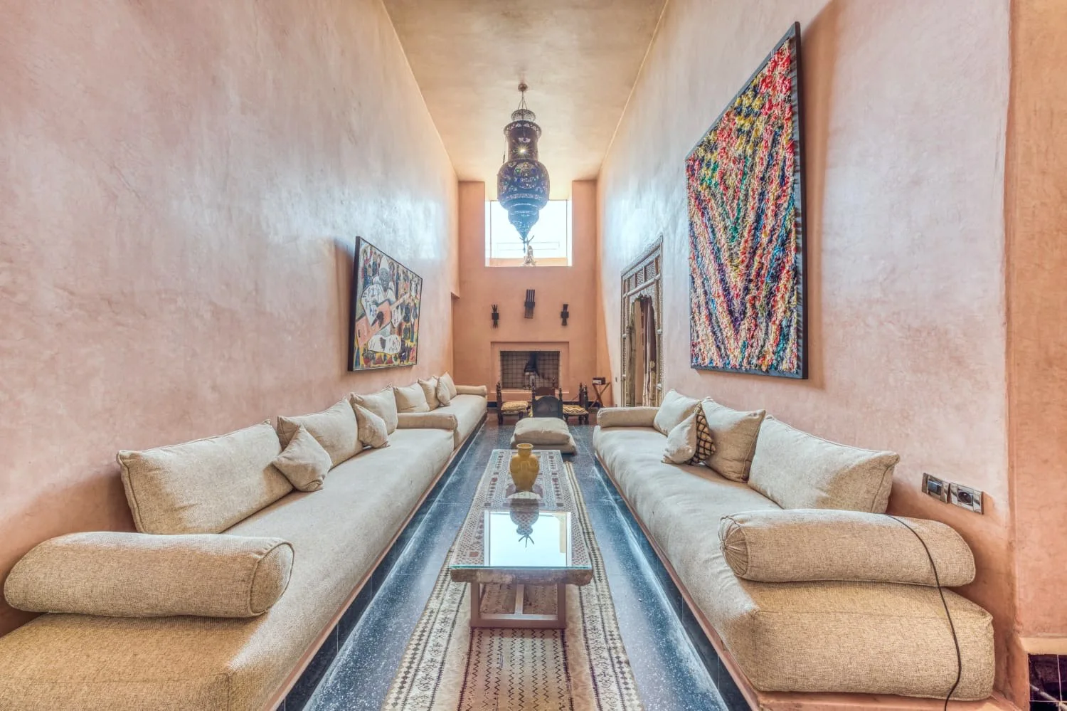Villa Ianthe, private villa rental in the Palmeraie, Marrakech: Moroccan salon with fireplace and woven textiles