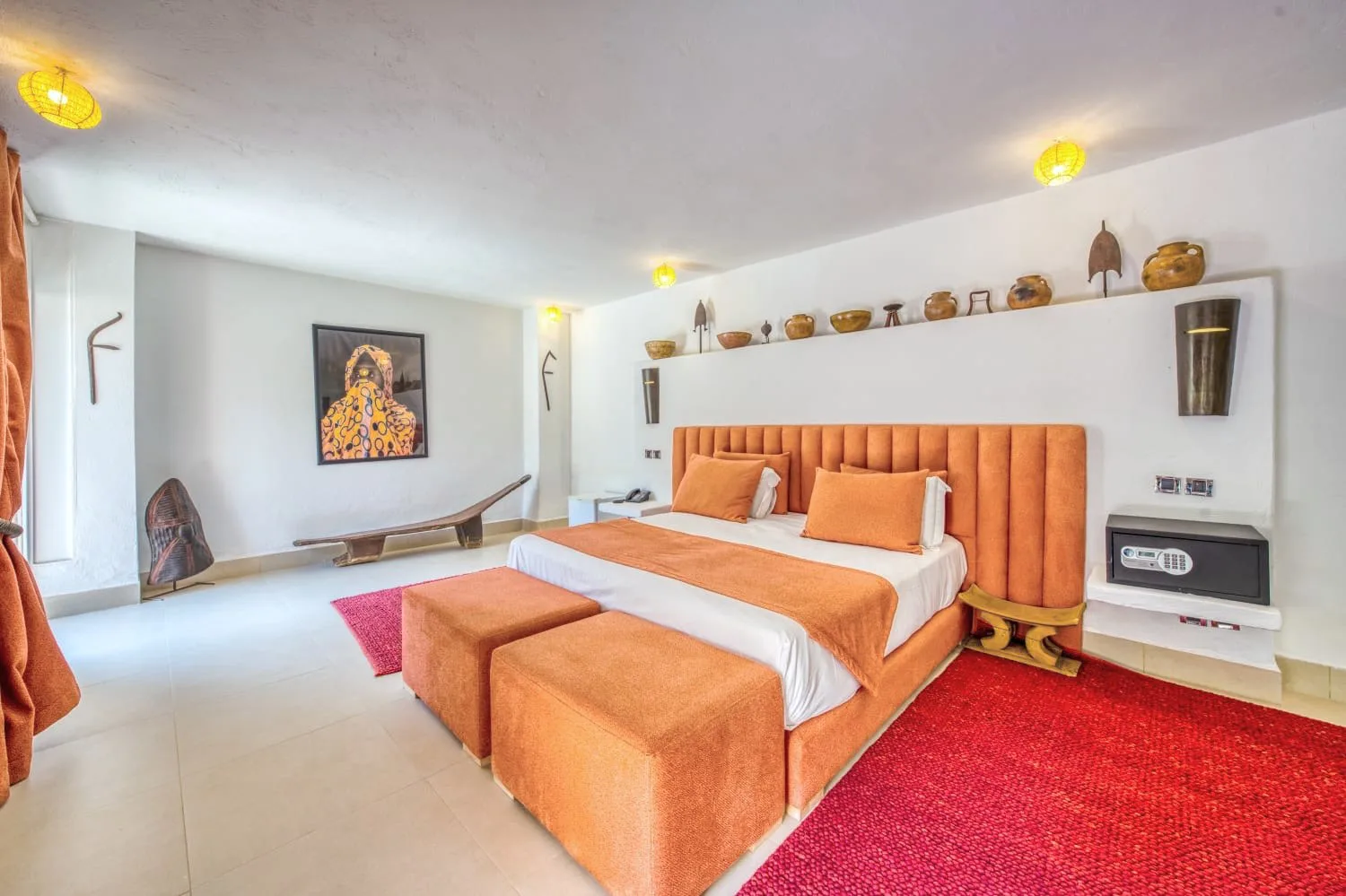 Villa Ianthe, private villa rental in the Palmeraie, Marrakech: bedroom with orange headboard and red rug