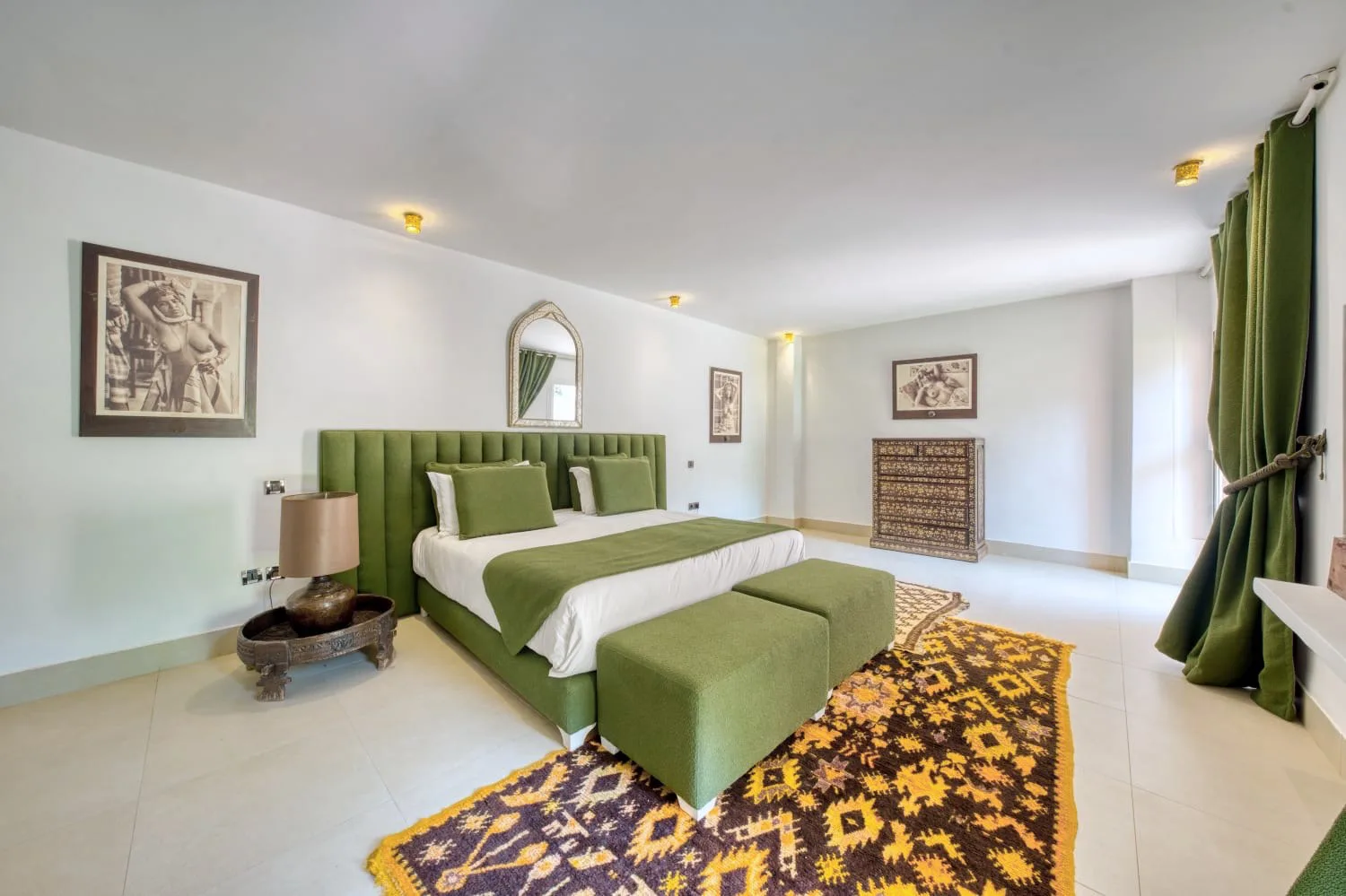 Villa Ianthe, private villa rental in the Palmeraie, Marrakech: bedroom with green headboard and Berber rug