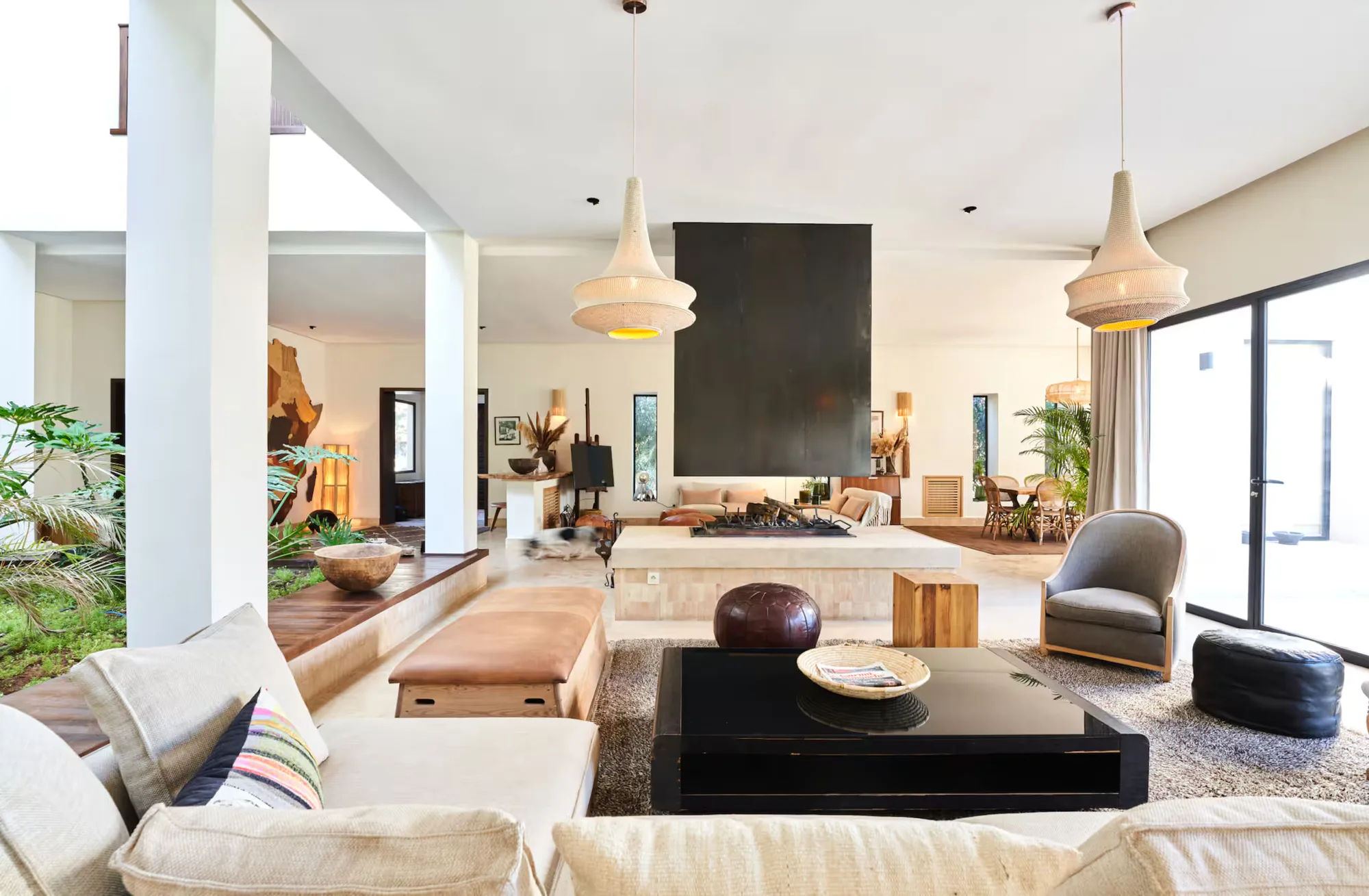 Villa Selene, private villa rental on the Route d'Amizmiz, Marrakech: open-plan living room with a fireplace wall