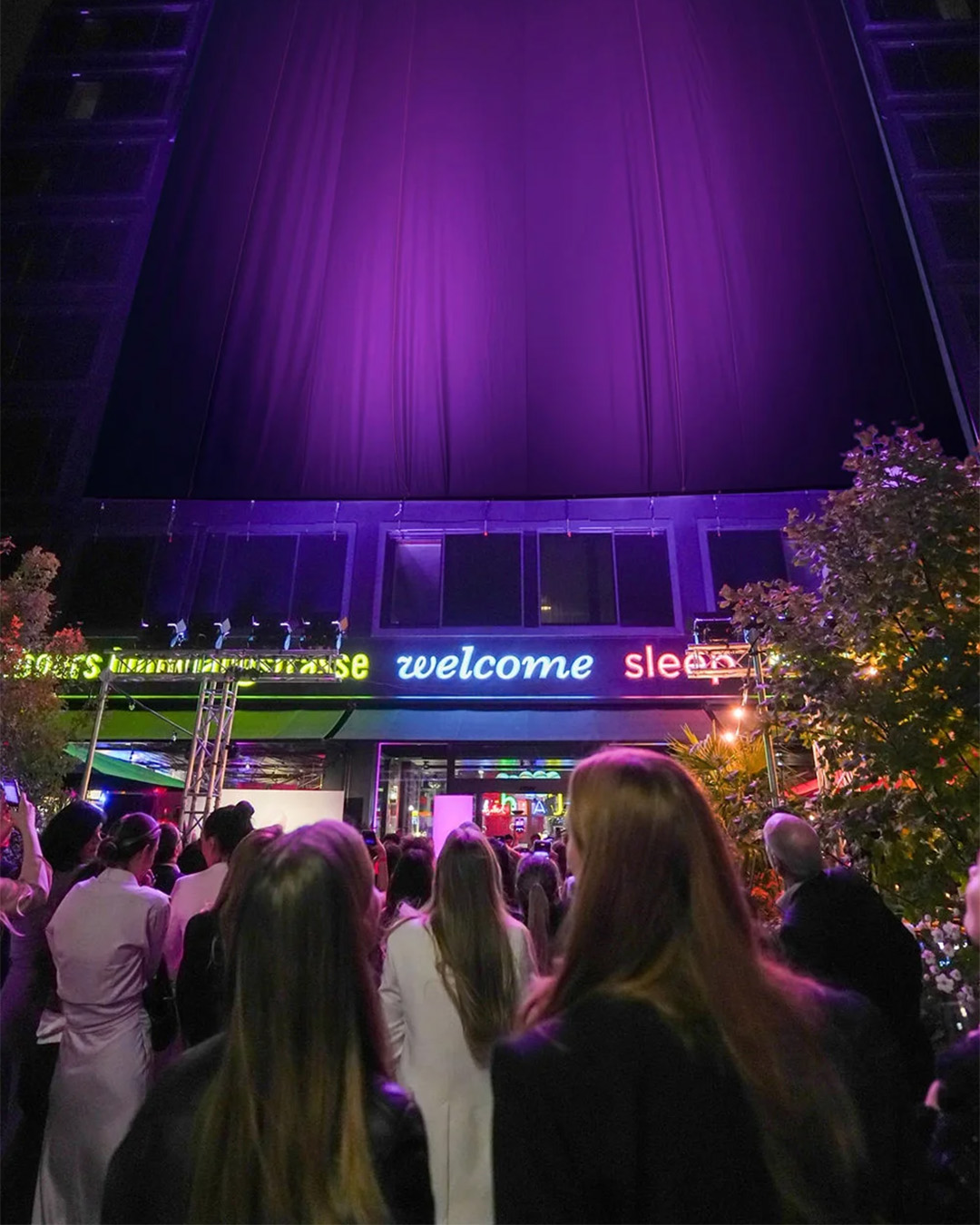 The artwork is illuminated in pink and is about to be unveiled