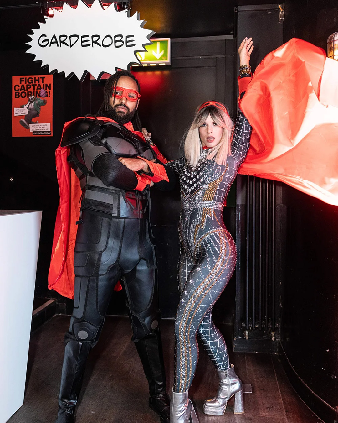Two hosts in superhero costumes