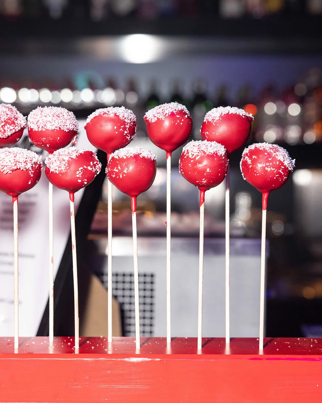 Red cake pops with shredded coconut