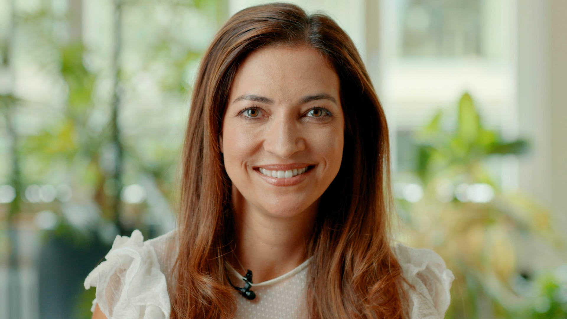 Portrait of a smiling participant in the "Bring Women Back to Work" program, which helps women re-enter the workforce.