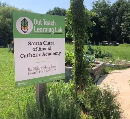 Out Teach Learning Lab sign at Santa Clara of Assisi Catholic Academy outdoor garden