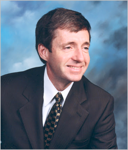 William Kent Headshot on blue background