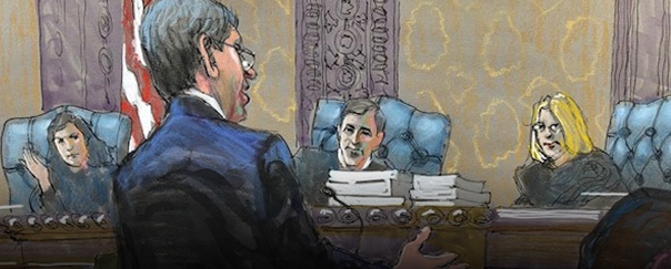 Courtroom sketch of a man speaking to three judges seated behind a bench with stacks of papers.