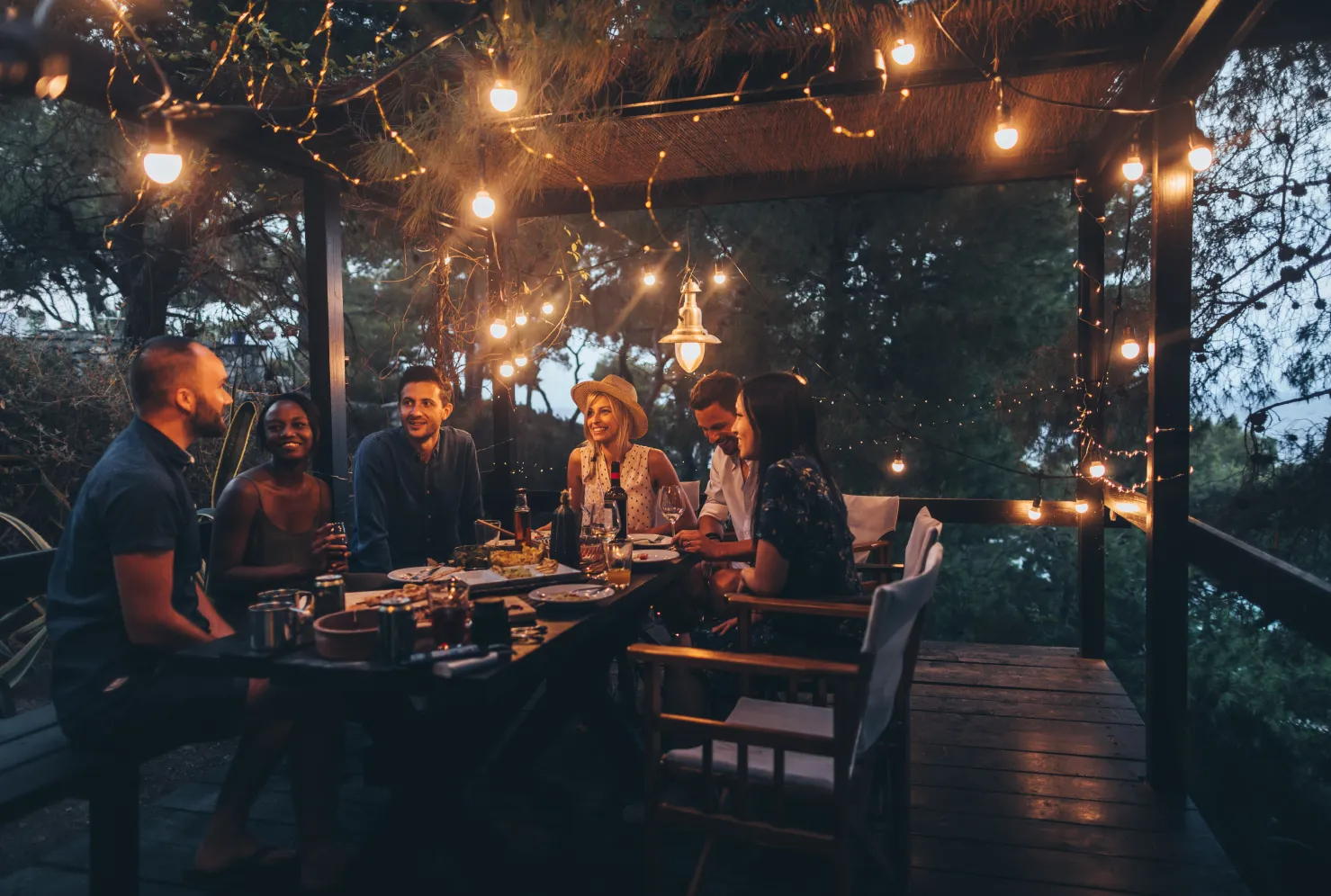 Friends gathered around dinner table stock image