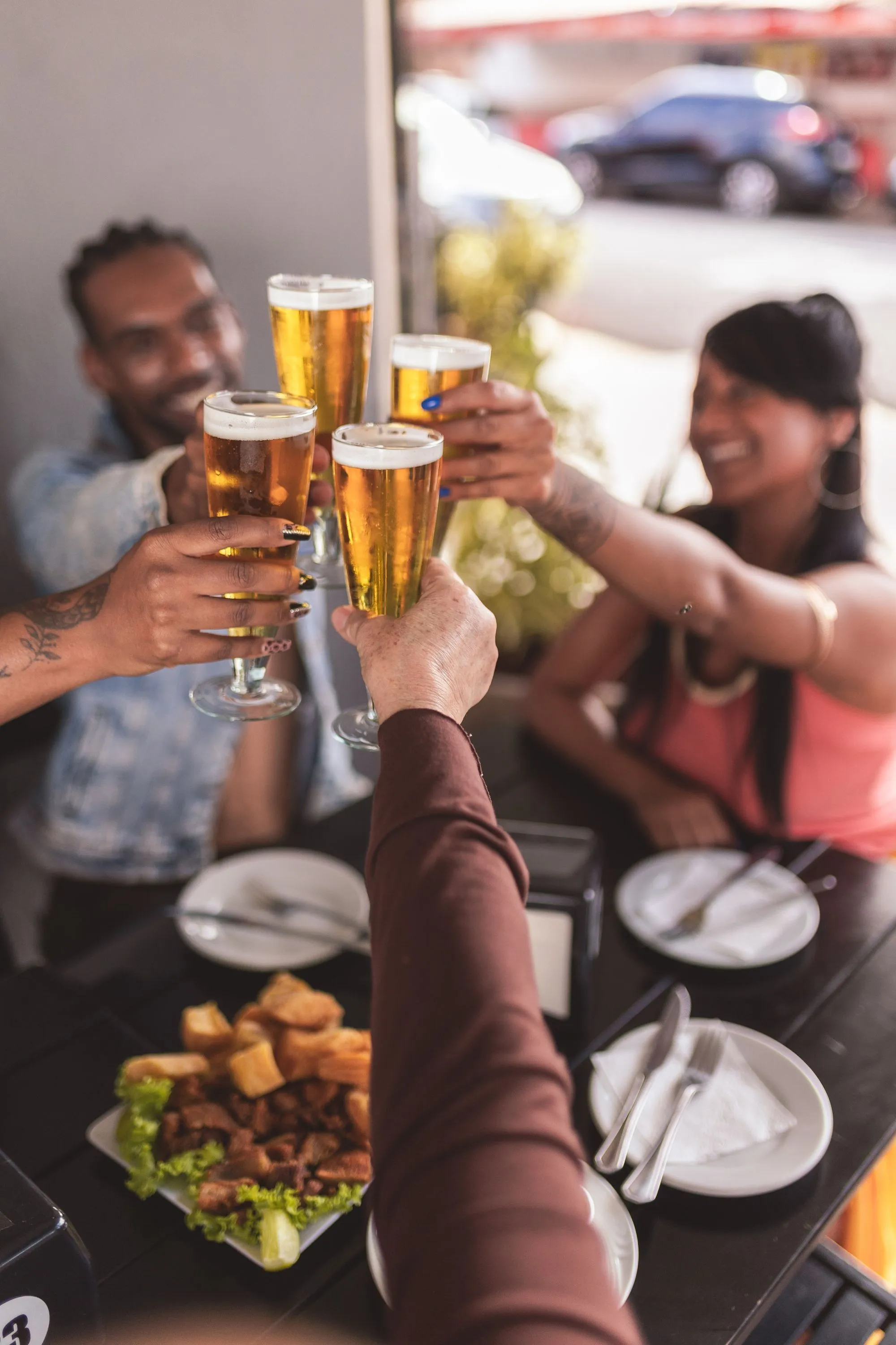 Friends cheering with drink glasses stock image