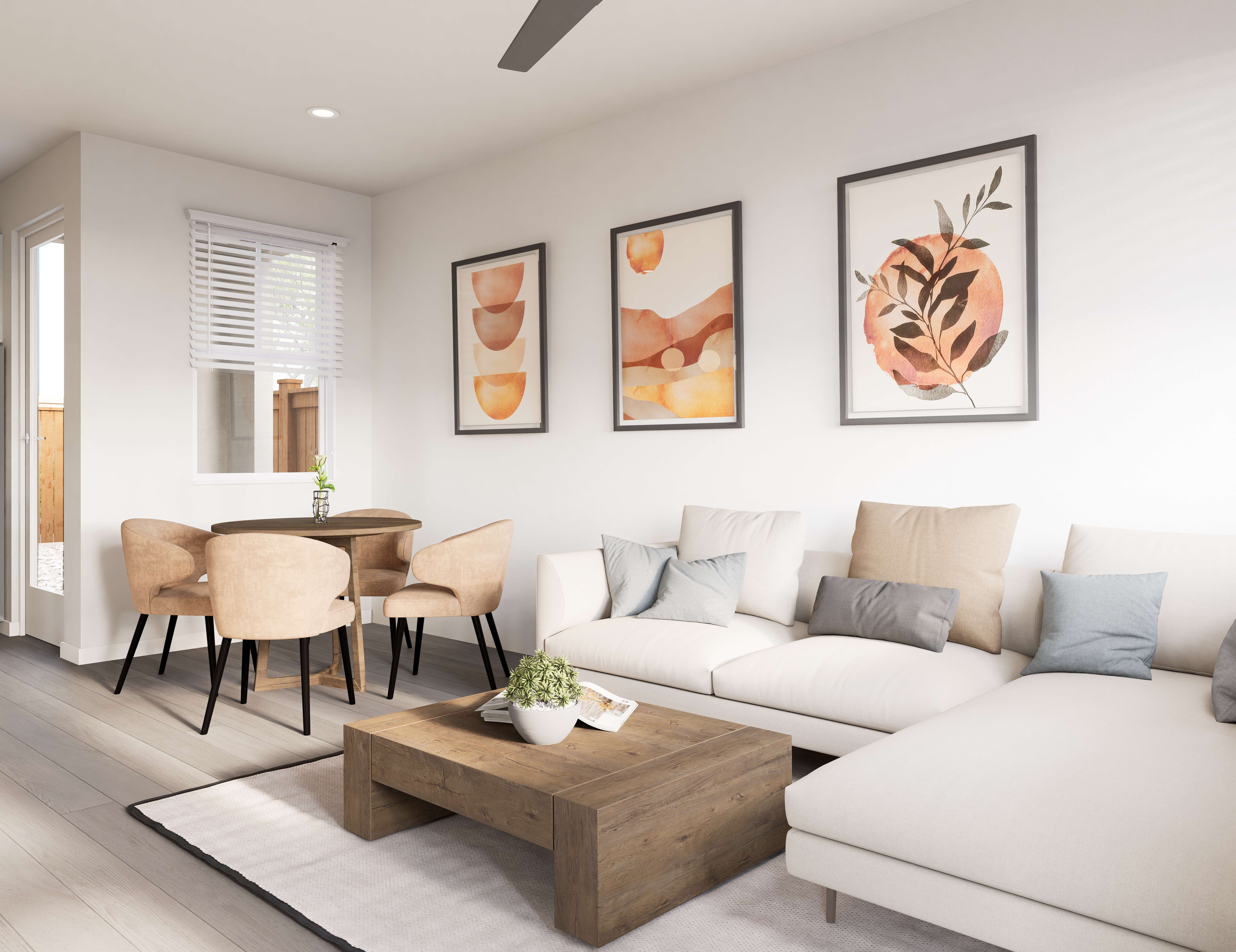Spacious open-concept living and dining area with a modern sofa, round table, and ceiling fan at The Eleanor Daytona Beach in Daytona Beach, Florida.