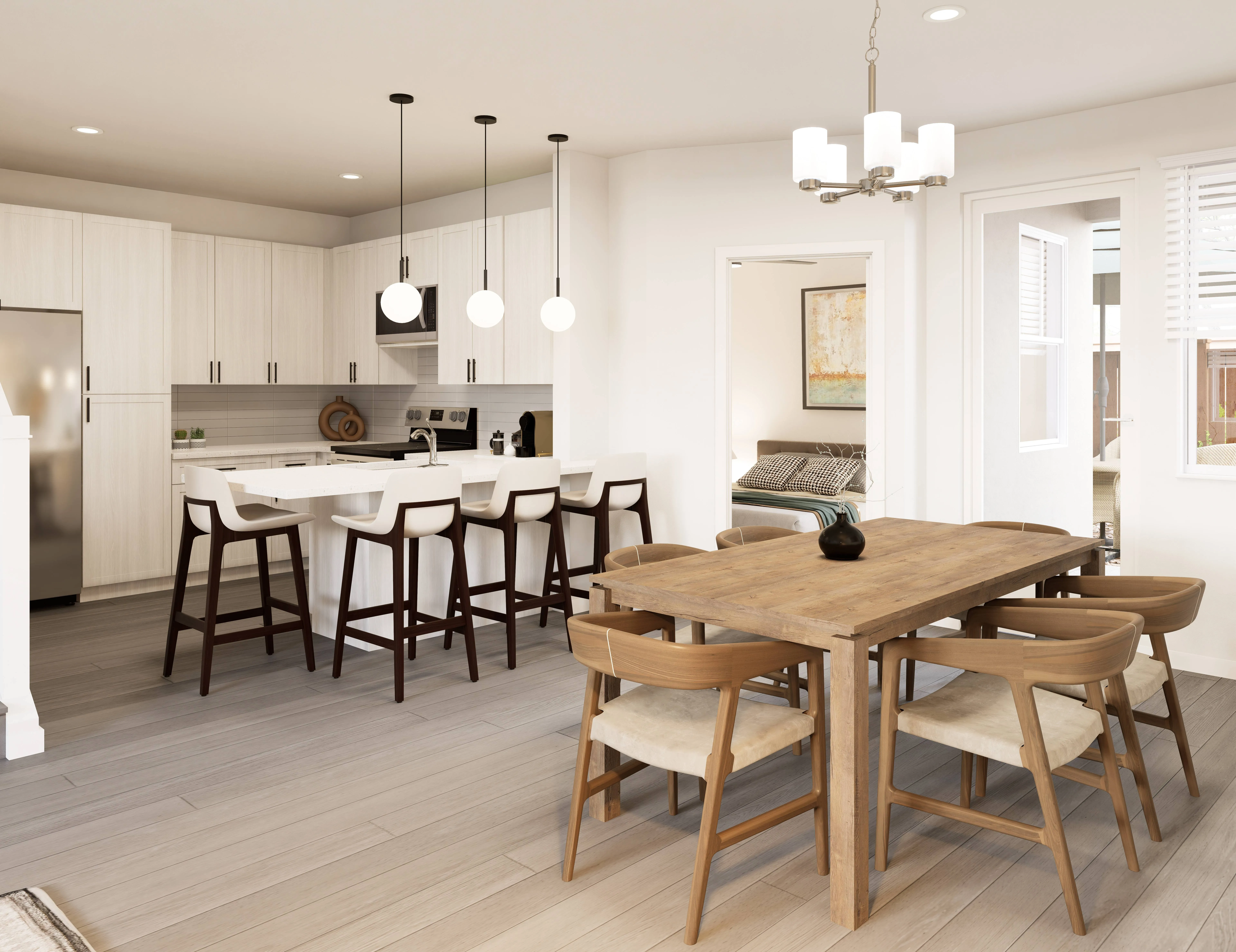Home kitchen with a large island and an adjacent wooden dining table for six, creating a great entertaining space at The Eleanor Daytona Beach in Daytona Beach, Florida.