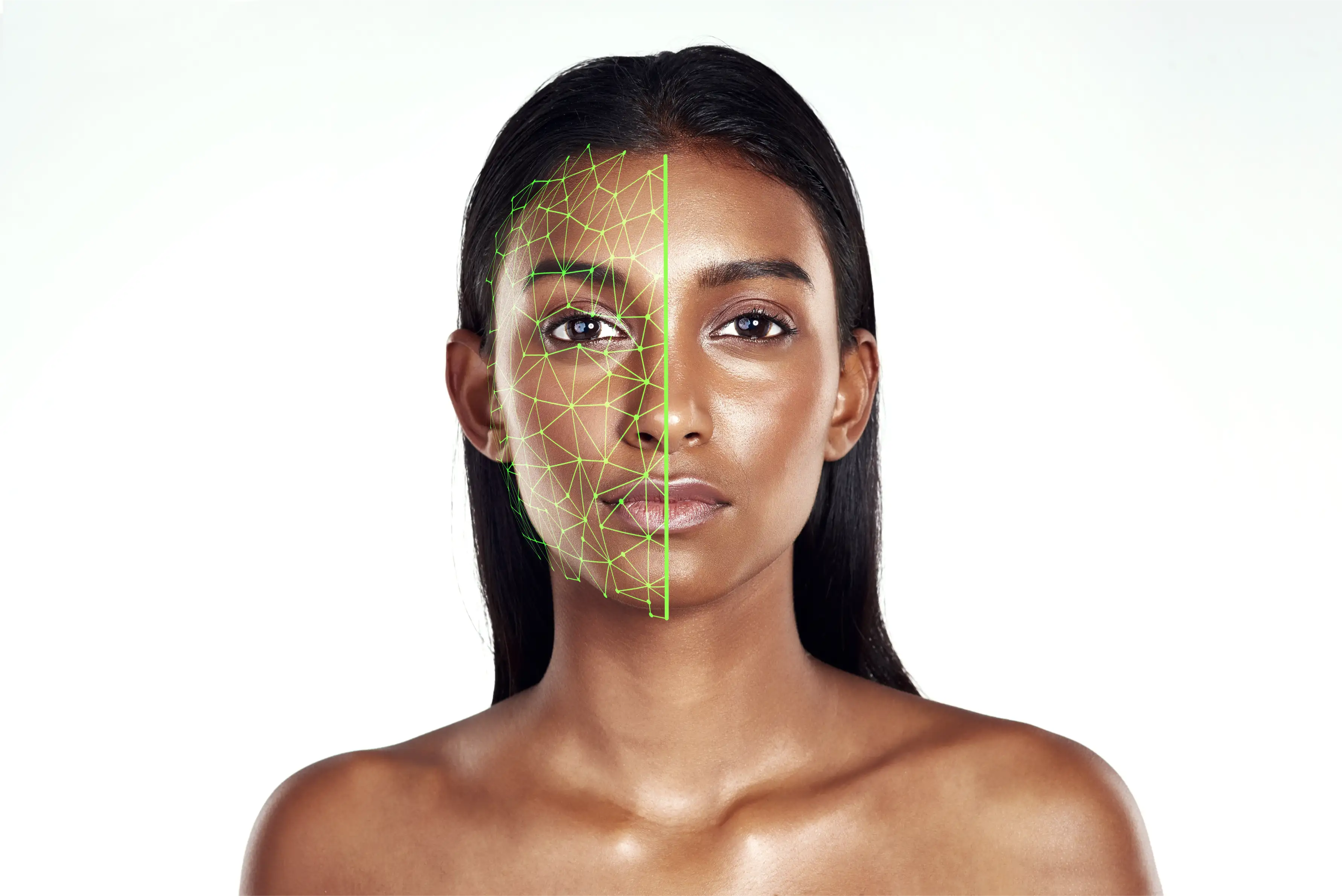 Portrait of a woman with half her face overlaid by a green facial recognition mesh.