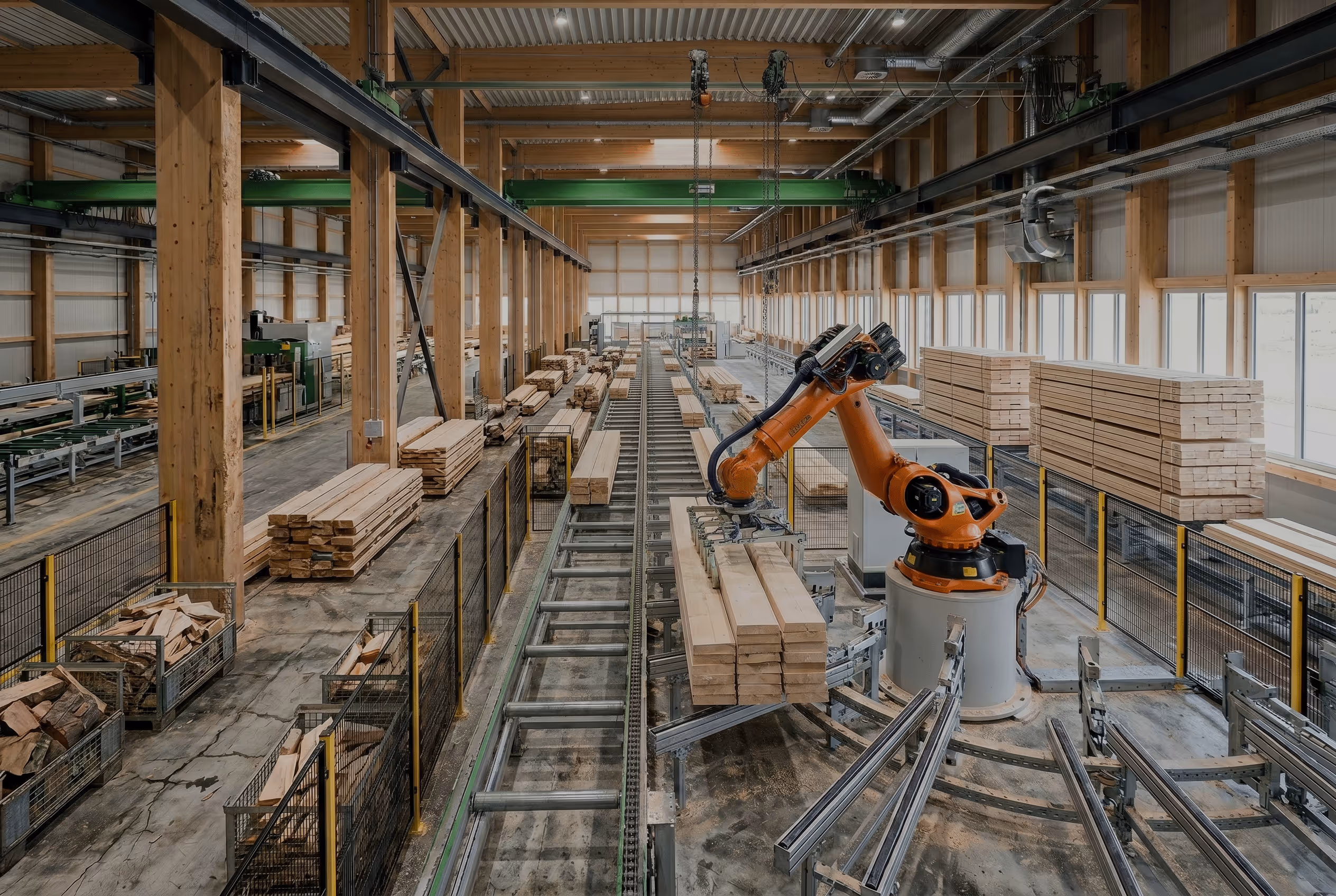 Industrial robotic arm handling stacked wooden planks in a large wood processing facility, shows where NeoMethanol can possibly be used