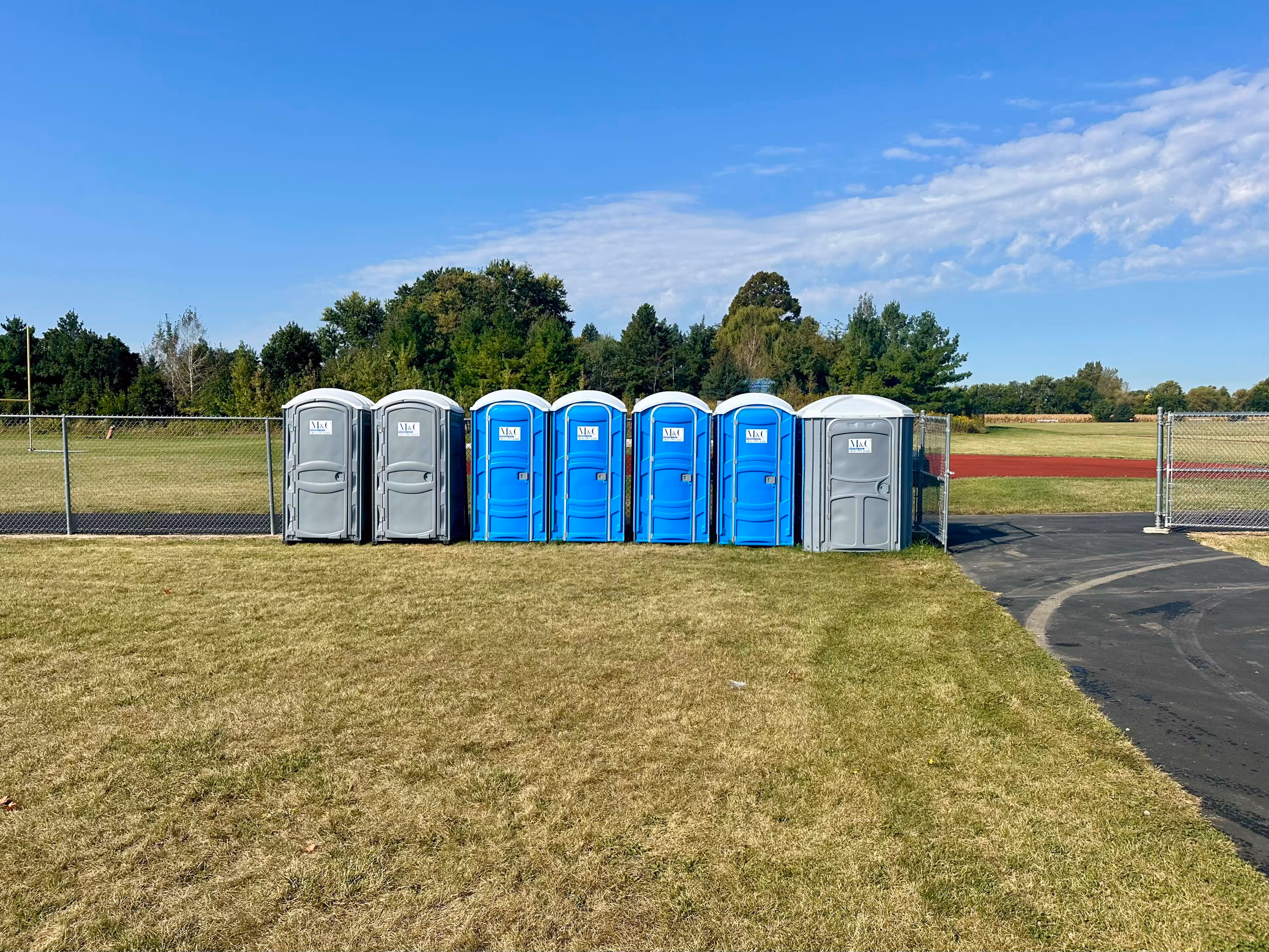 m-and-c-rentals-picture-with-blue-porta-potties-and-gray-porta-potties