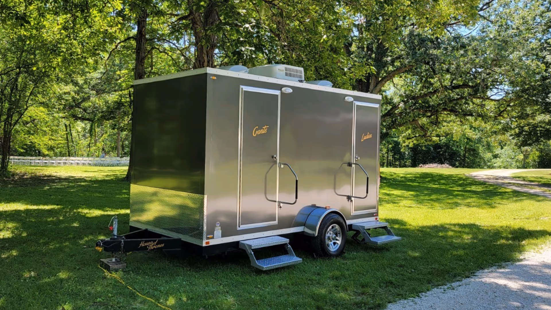 restroom-trailer-chicagoland-in-open-field-area-with-multiple-trees