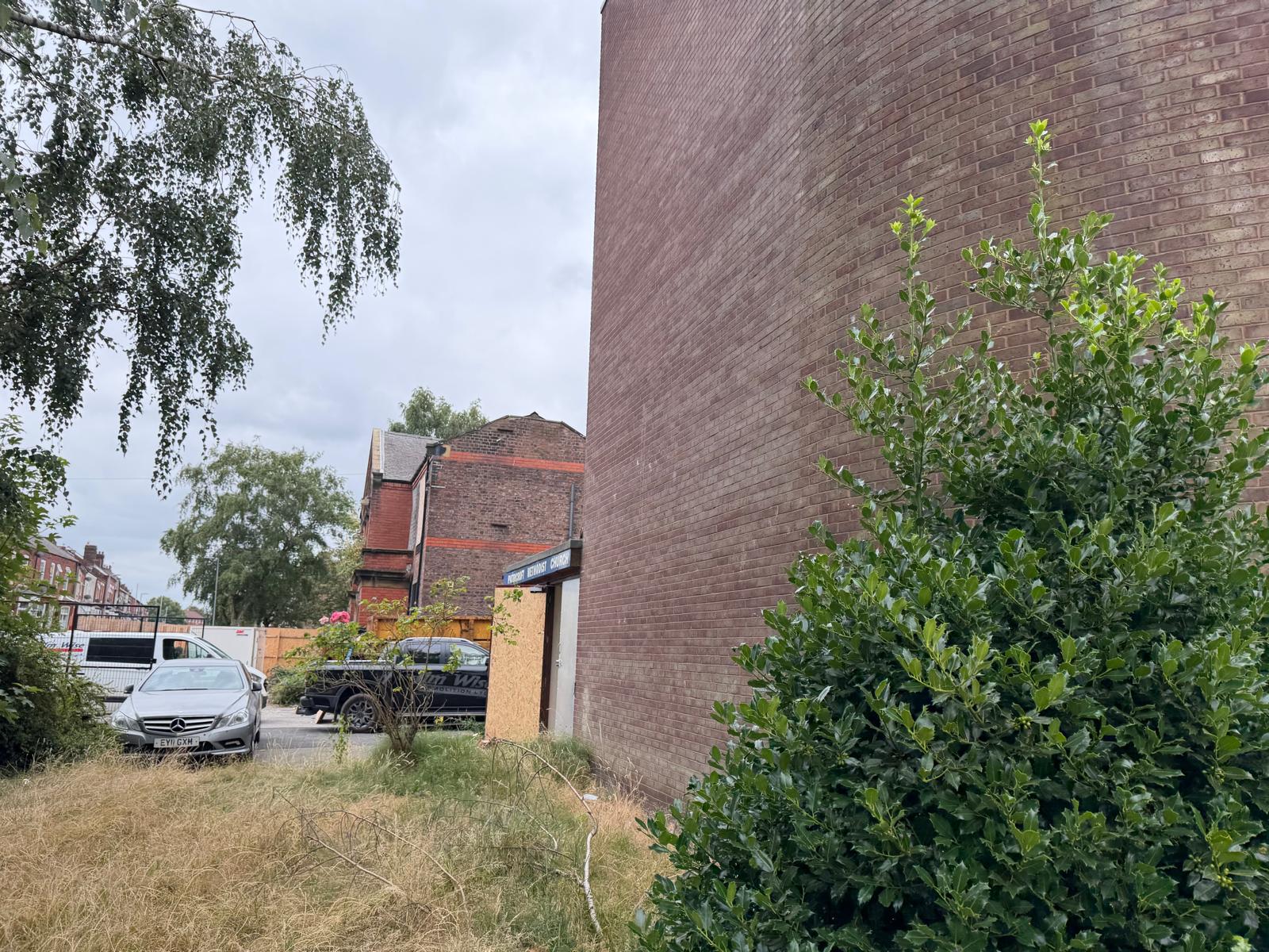 Segregated demolition arisings and reclaimed brick loaded for recycling at the Eccles church site