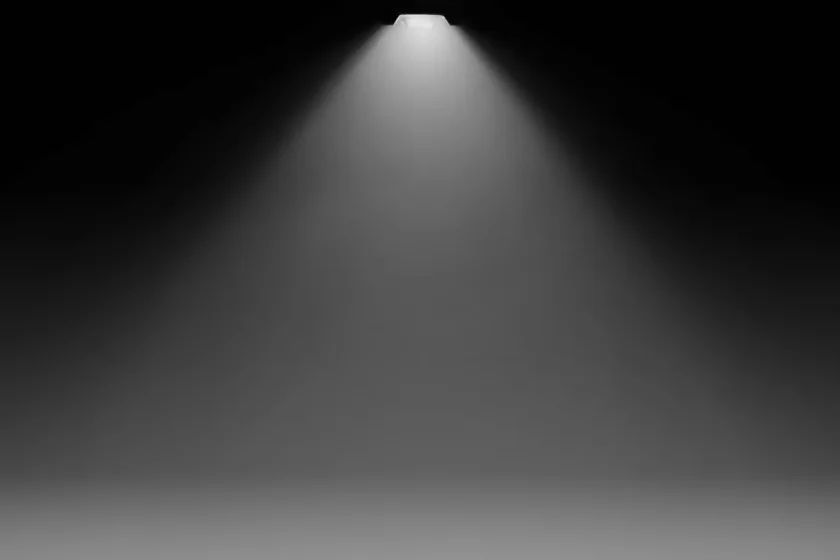 A bright overhead streetlight illuminating a dark path, symbolizing radical transparency, clear communication, and structured feedback. 