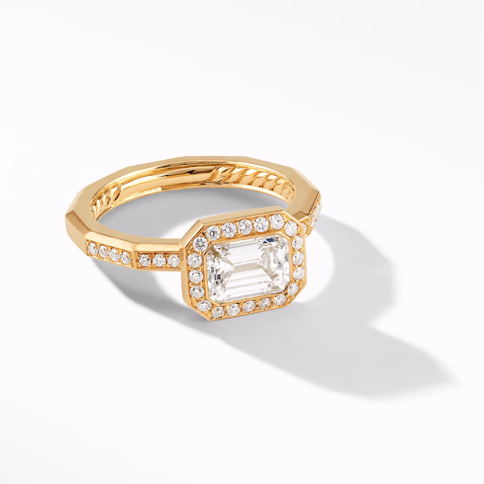 Gold ring with a rectangular center stone and surrounding clear stones