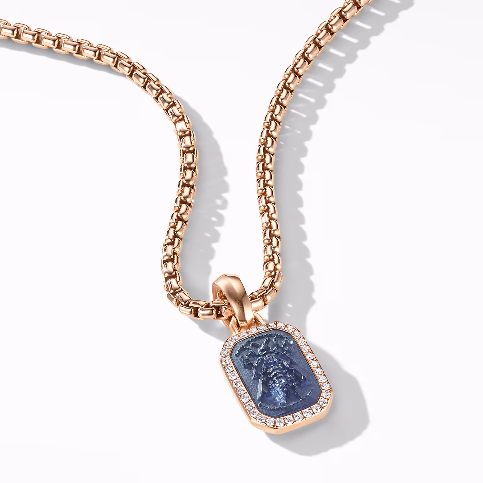 Rose-gold chain with a blue rectangular pendant and clear stones
