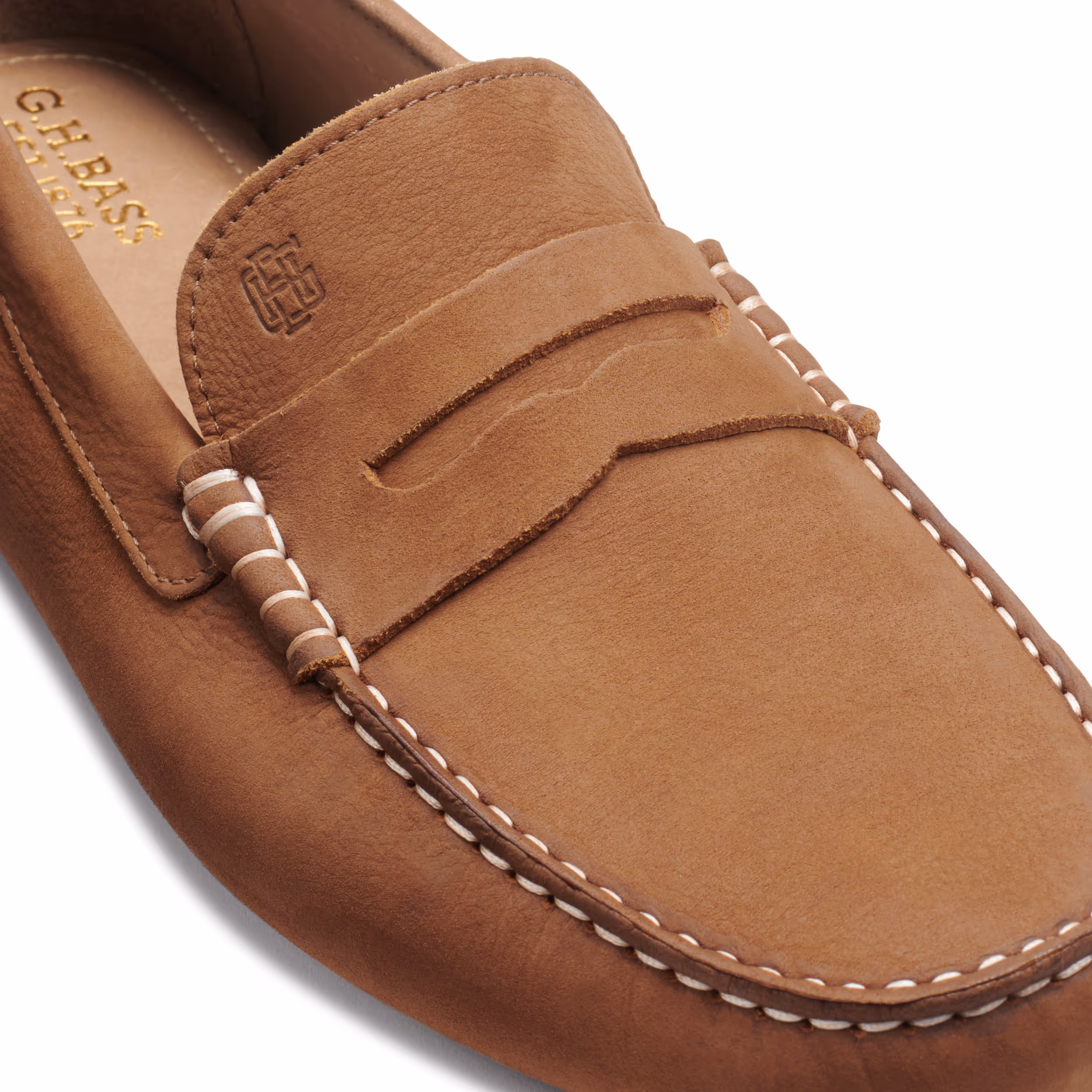 Close-up of a brown suede penny loafer with contrast stitching