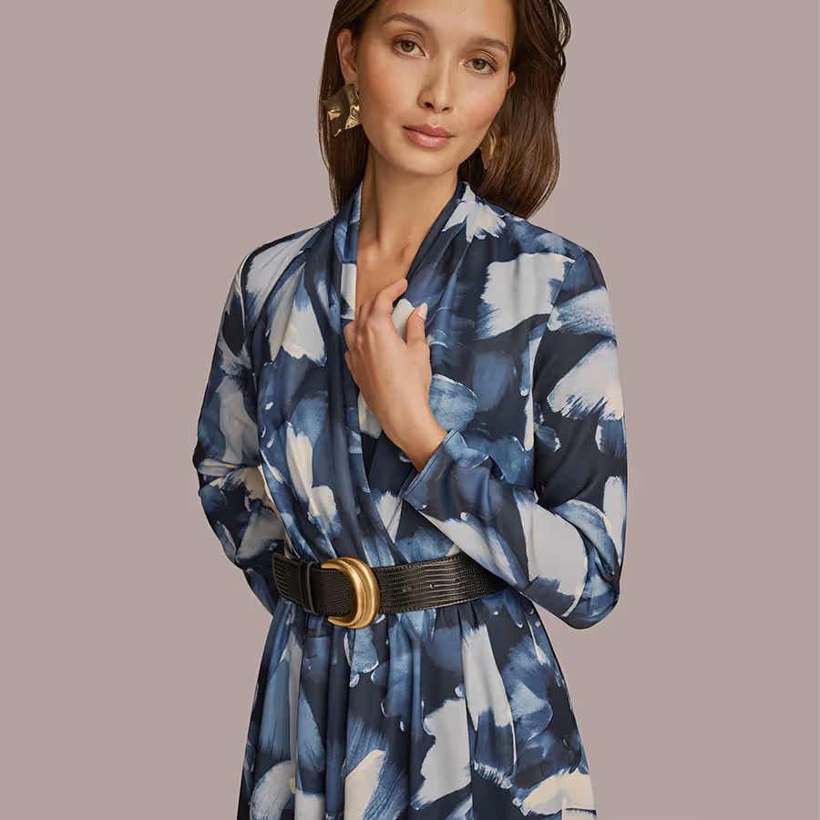 Model wearing a blue patterned dress with a black belt
