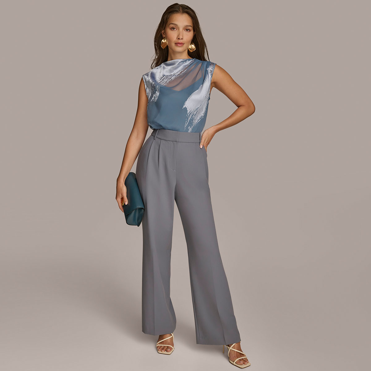 Full-length model in a blue-gray blouse and wide-leg trousers