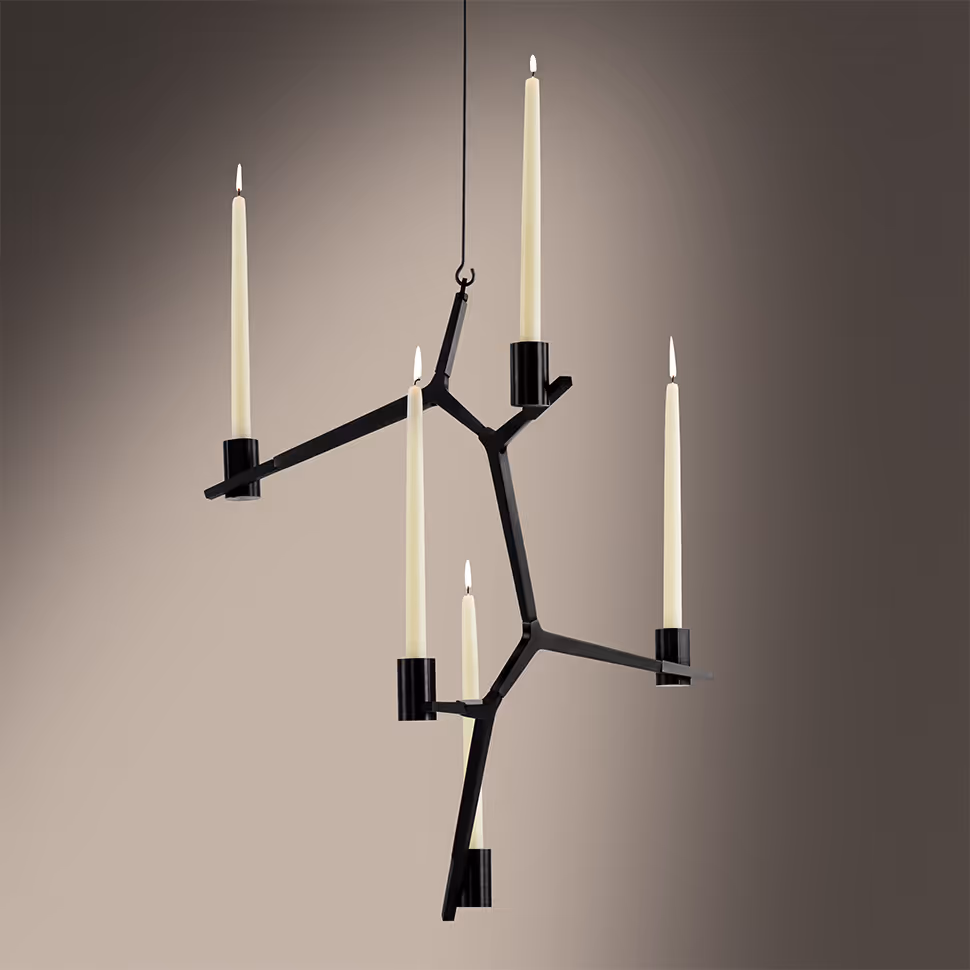 Black sculptural candleholder with added lighting and a wall shadow after compositing
