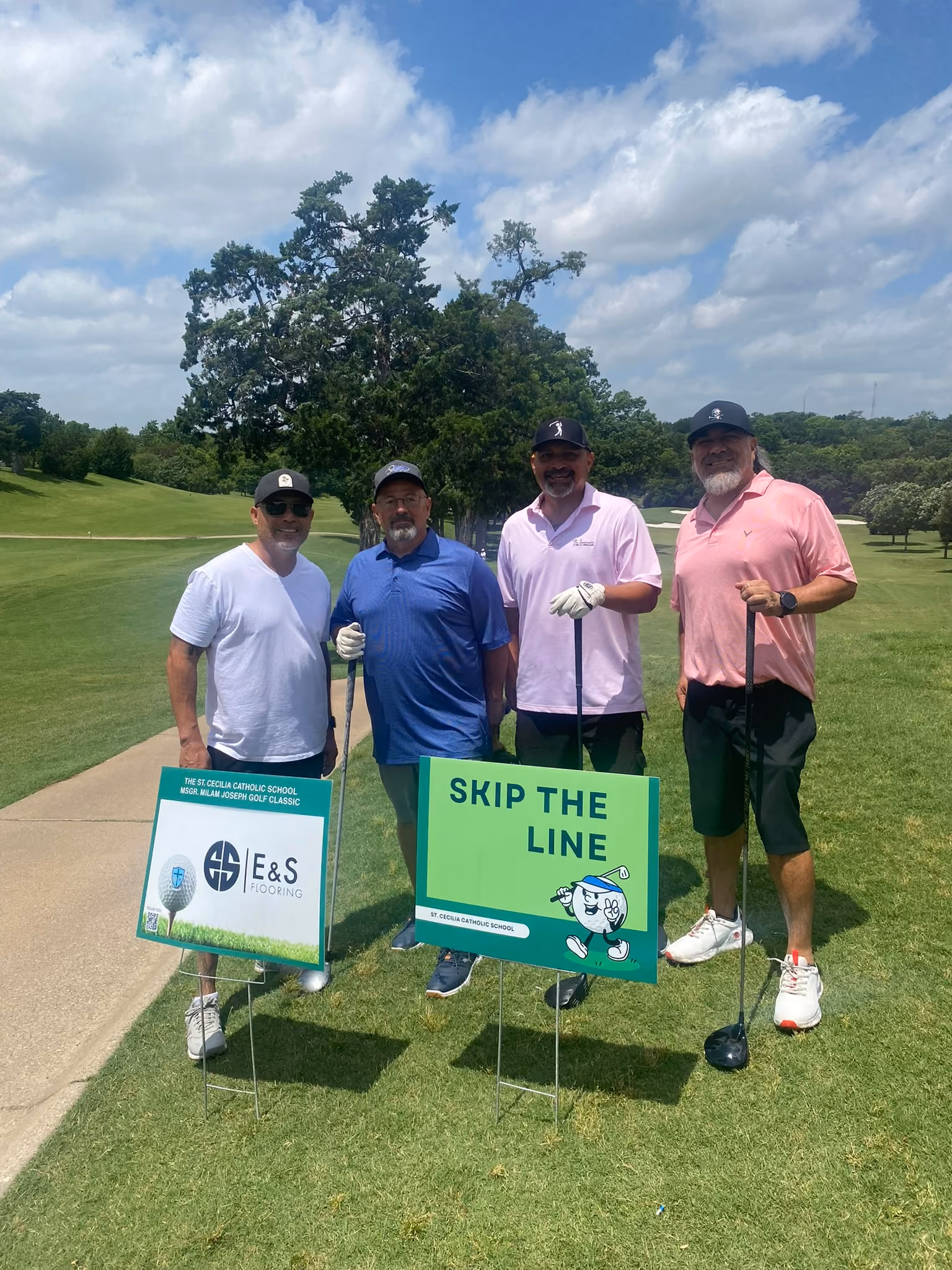 Four golfers pose at St Cecilia Catholic School golf classic fundraiser