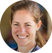 Smiling female healthcare provider wearing a stethoscope.