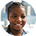 Smiling woman with braided hair wearing a black turtleneck and gold hoop earrings.