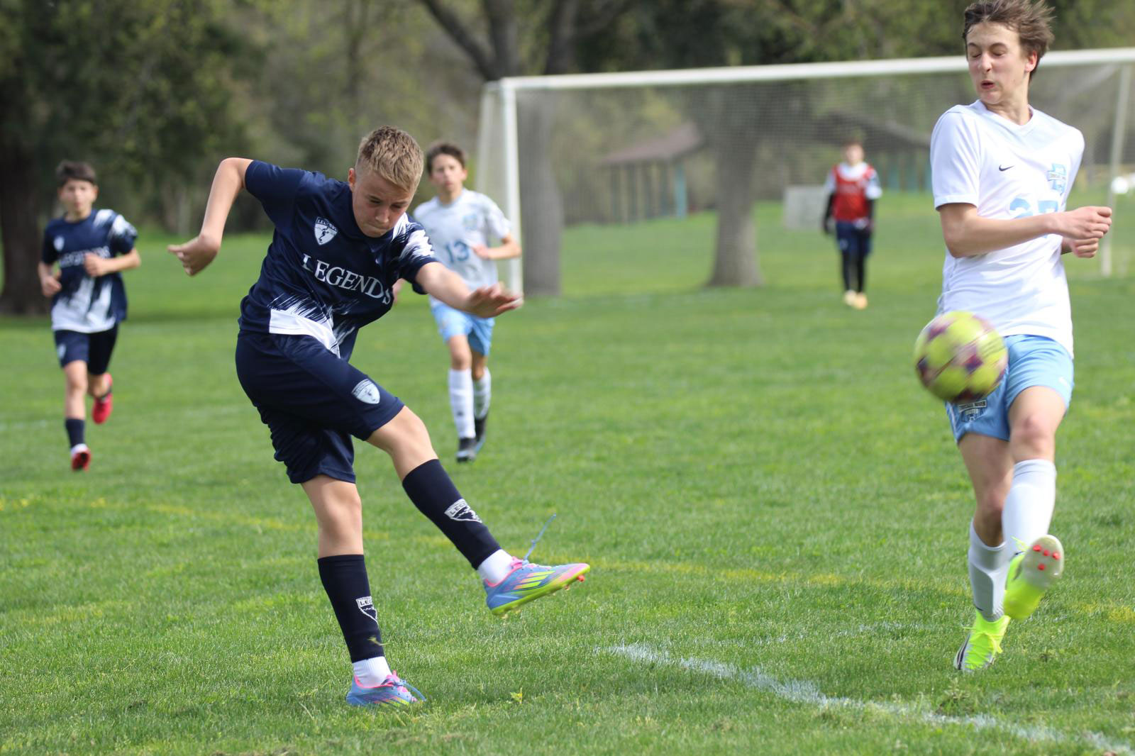 Legends player kicks the ball