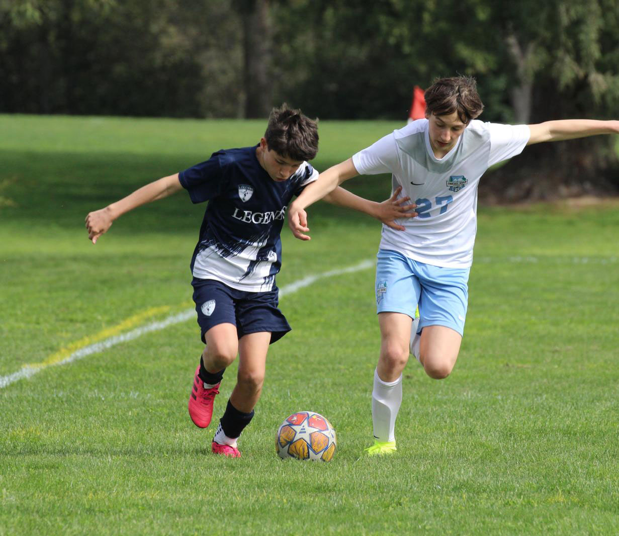 Legends player is trying to keep possession of the ball