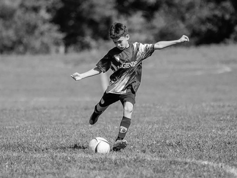 Legends 2017 player kicking the ball