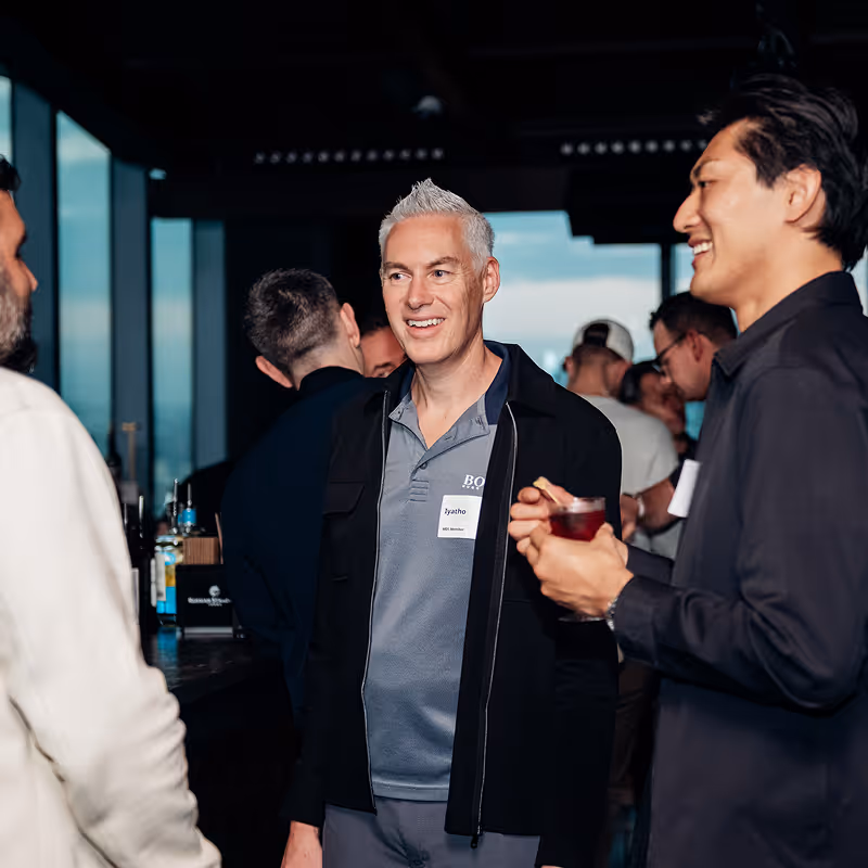 Attendees socializing at an Ecompreneur event with drinks